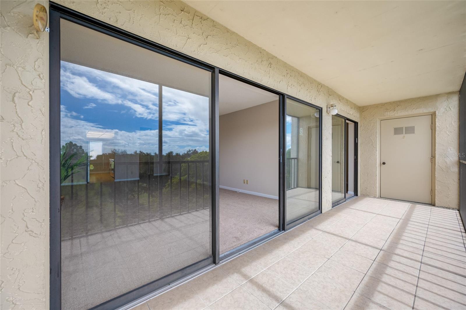 Sliding doors offers direct access to lanai from living area and from primary bedroom