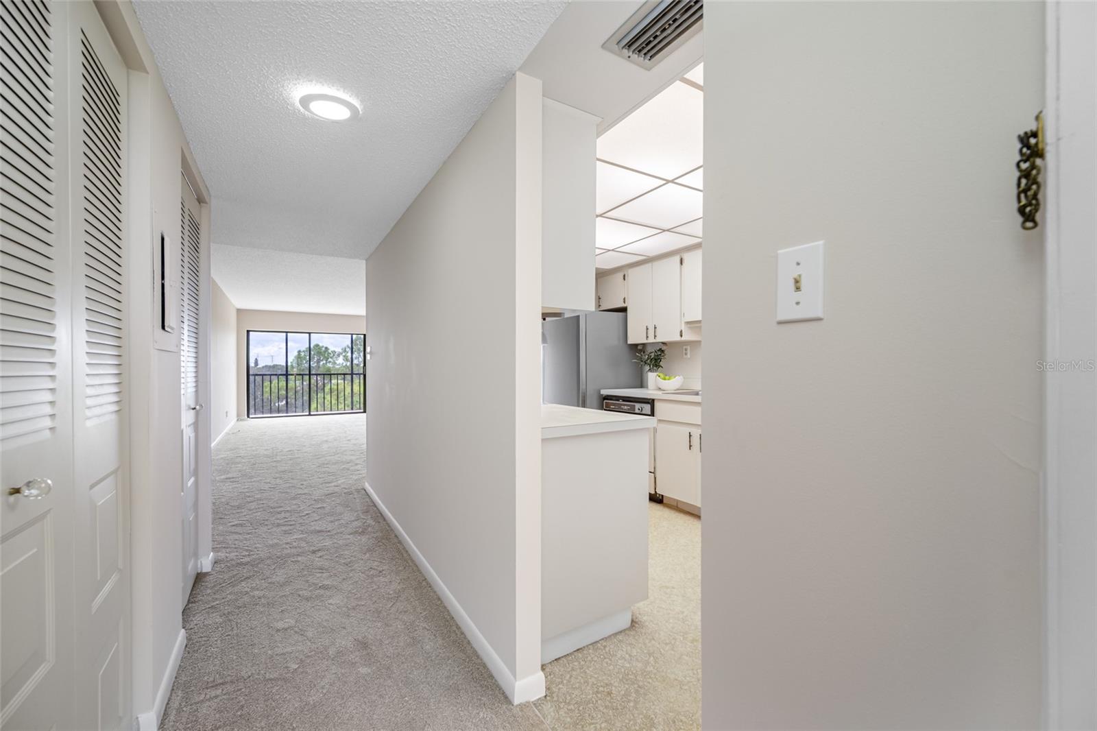 Foyer entry with kitchen located to the right