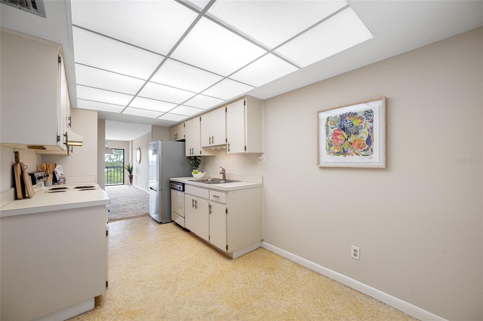 Kitchen with newer stainless steel refrigerator