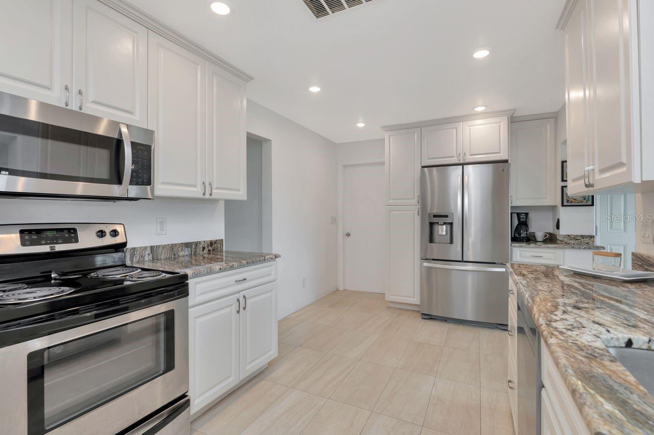 Gourmet kitchen with slab granite and updated cabinets
