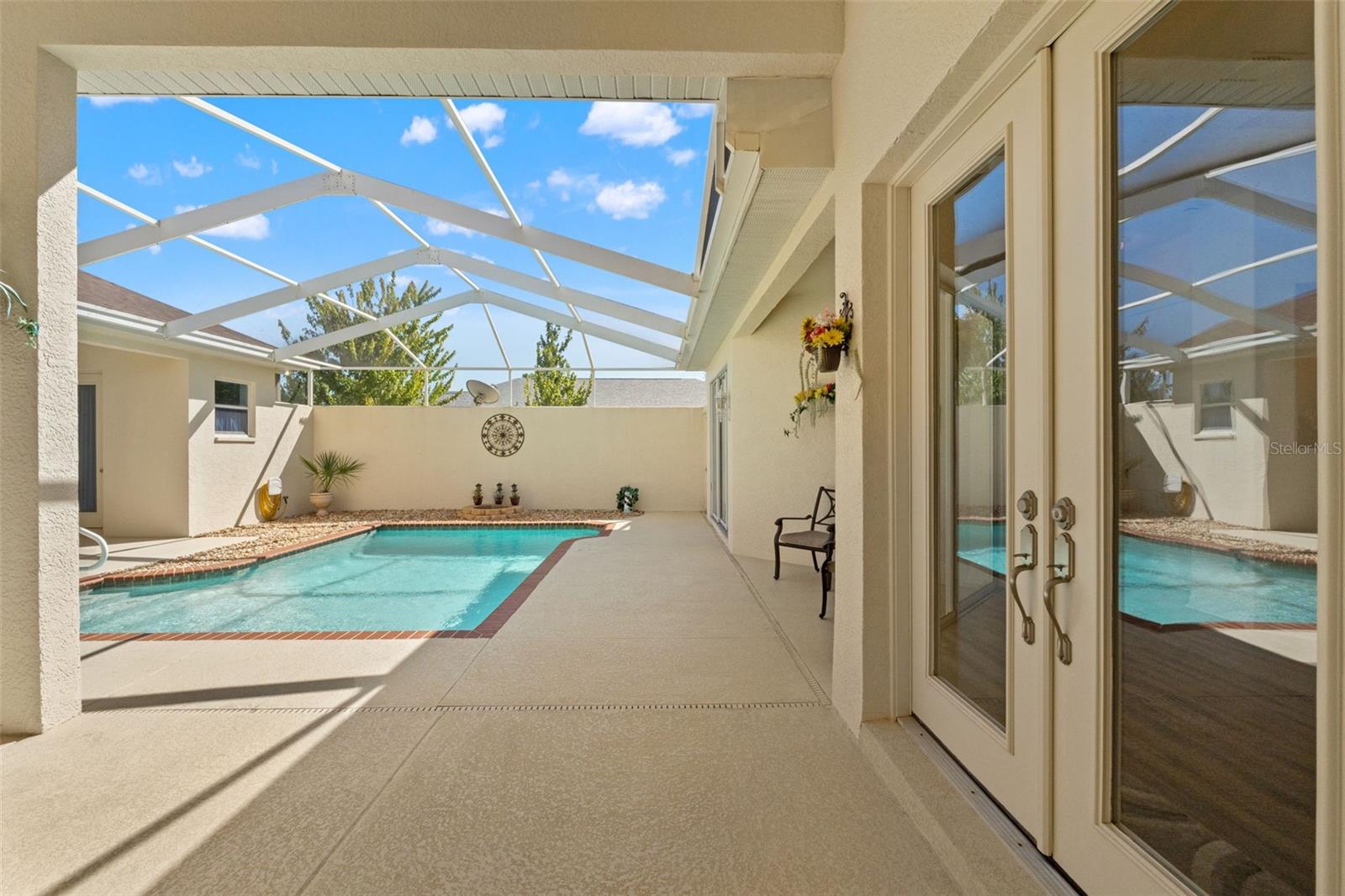 Screen enclosed courtyard with pool