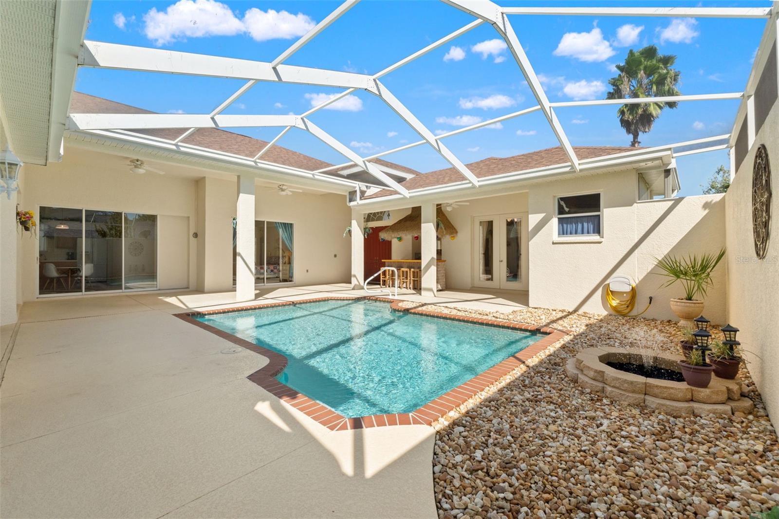 Screen enclosed courtyard with pool
