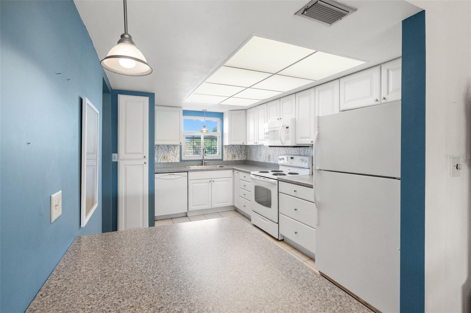 The thoughtfully updated kitchen features a breakfast bar.
