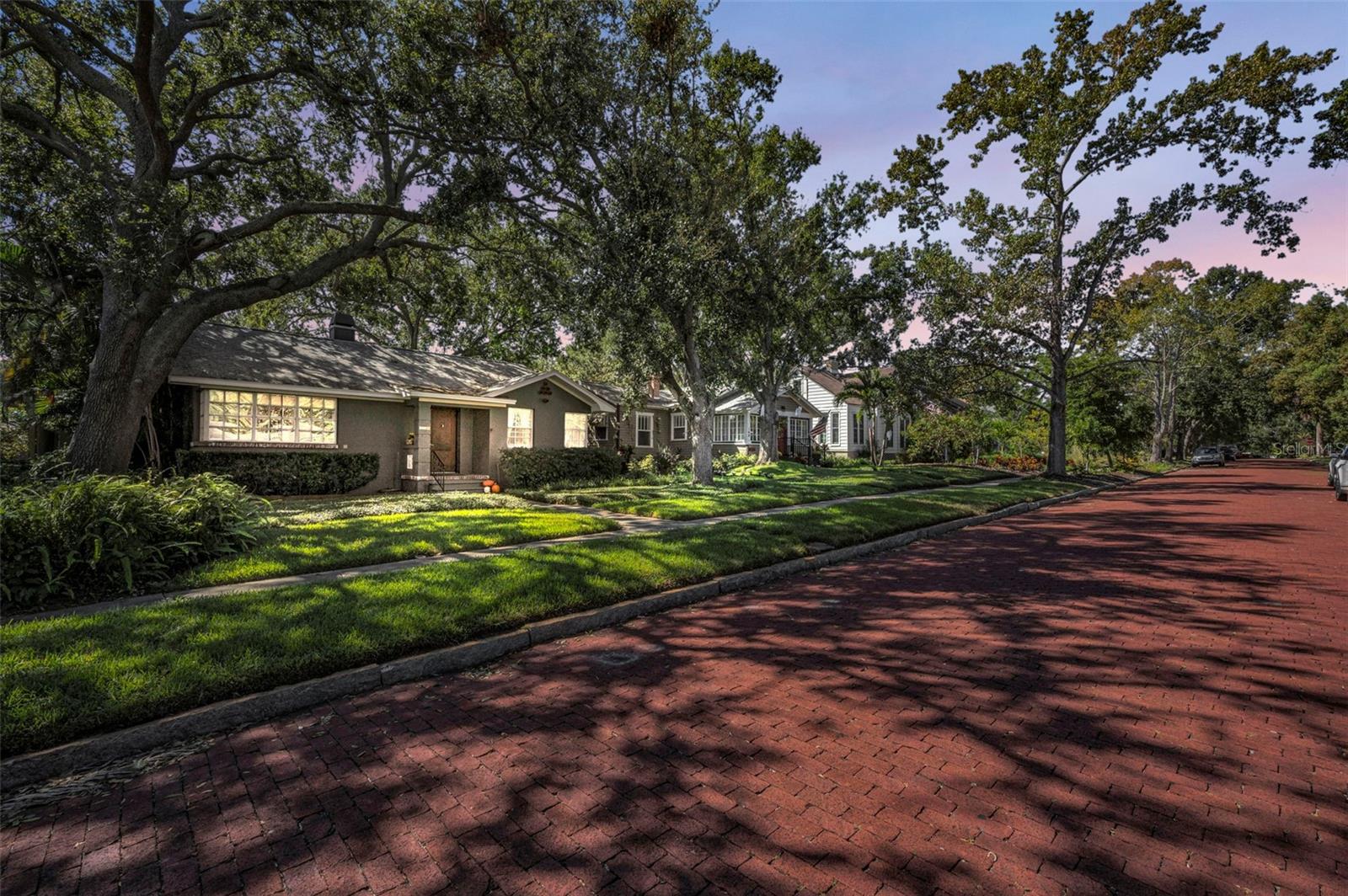 Nestled on a picturesque, wide, tree-lined brick street with sidewalks AND parking allowed on both sides!