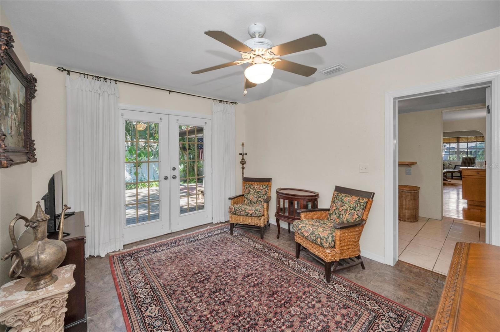 Primary Bedroom offers privacy with an en-suite bathroom, walk-in closet and French doors leading to the backyard.