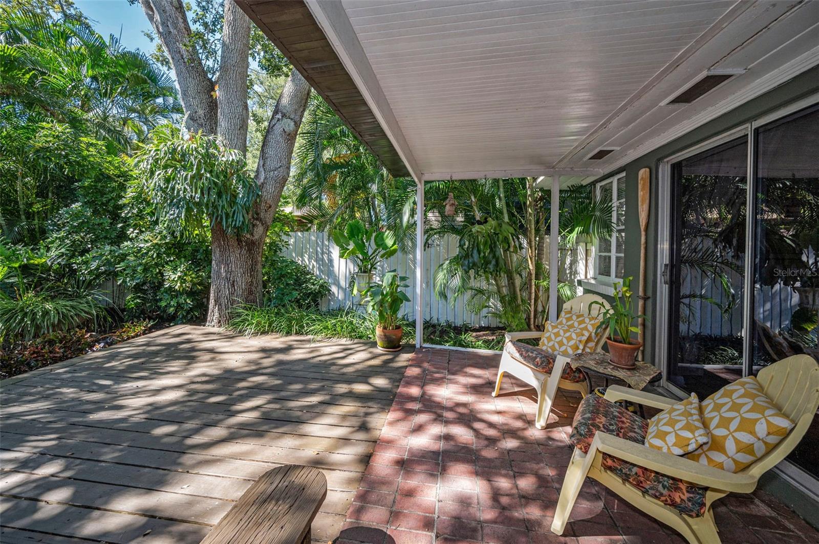 Enjoy peaceful mornings or quiet evenings on this spacious deck surrounded by lush greenery.