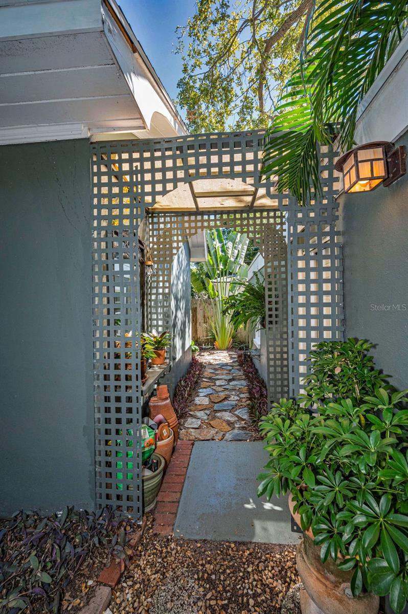 This charming walkway leads to your detached two car garage with paved alley access AND additional parking under your covered carport.  Ample parking and storage!