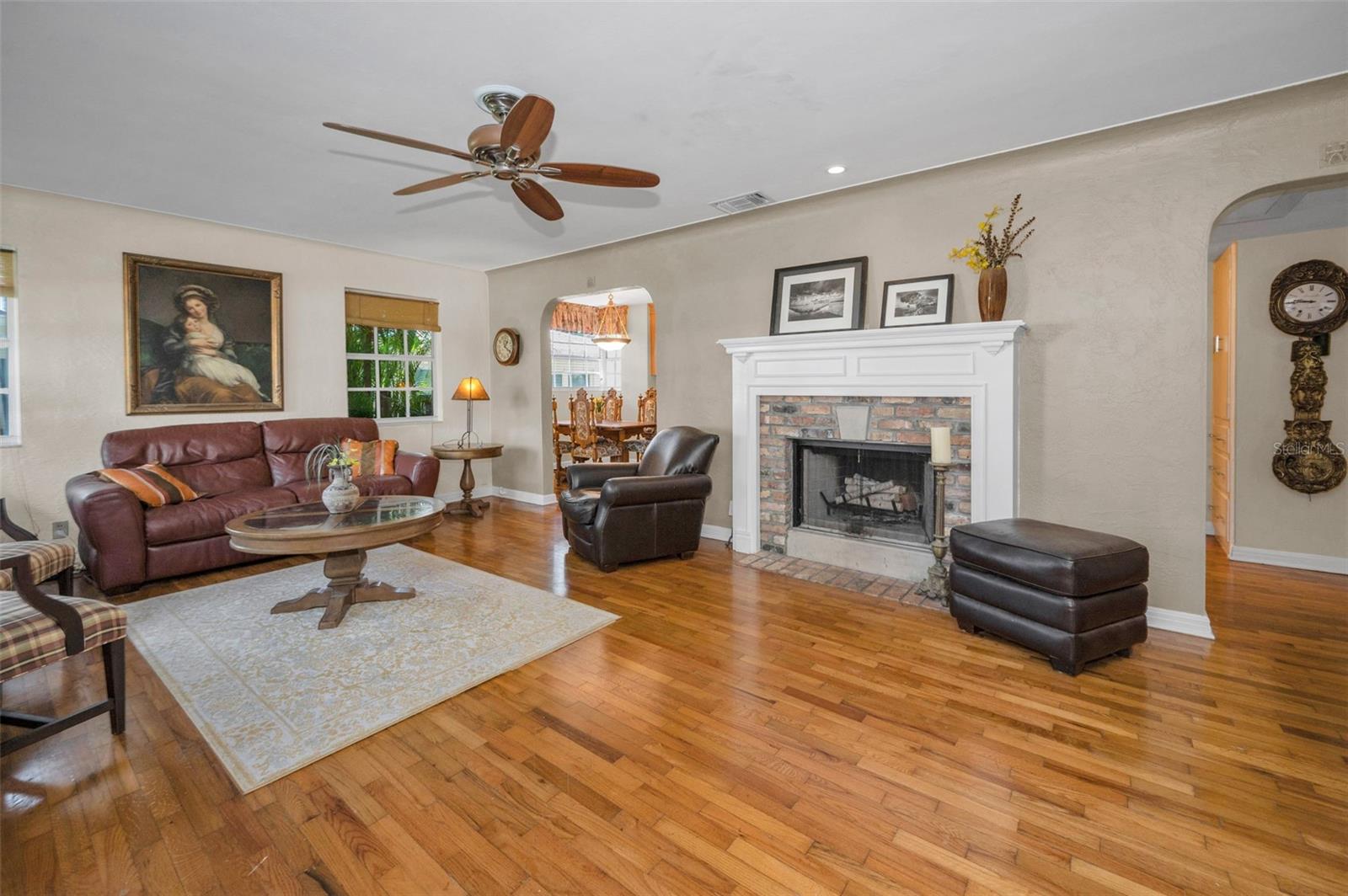 Incredible features such as  a wood-burning fireplace, gleaming oak floors, and elegant cove ceilings