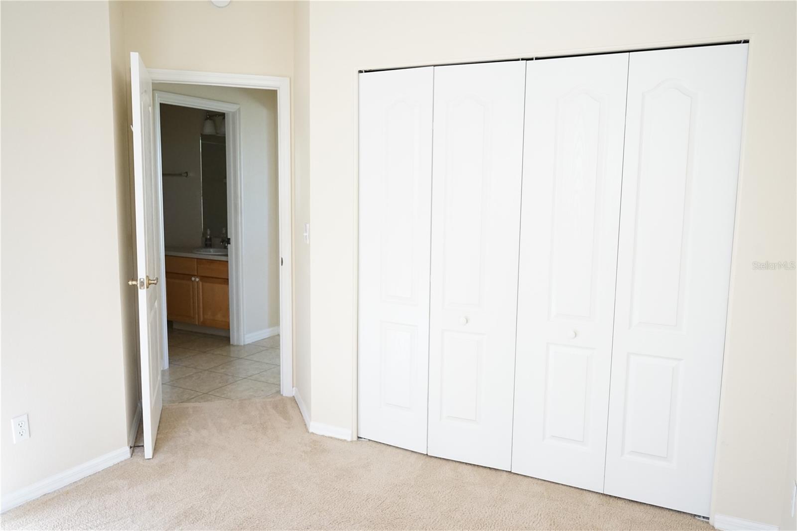 guest closet with door to hallway
