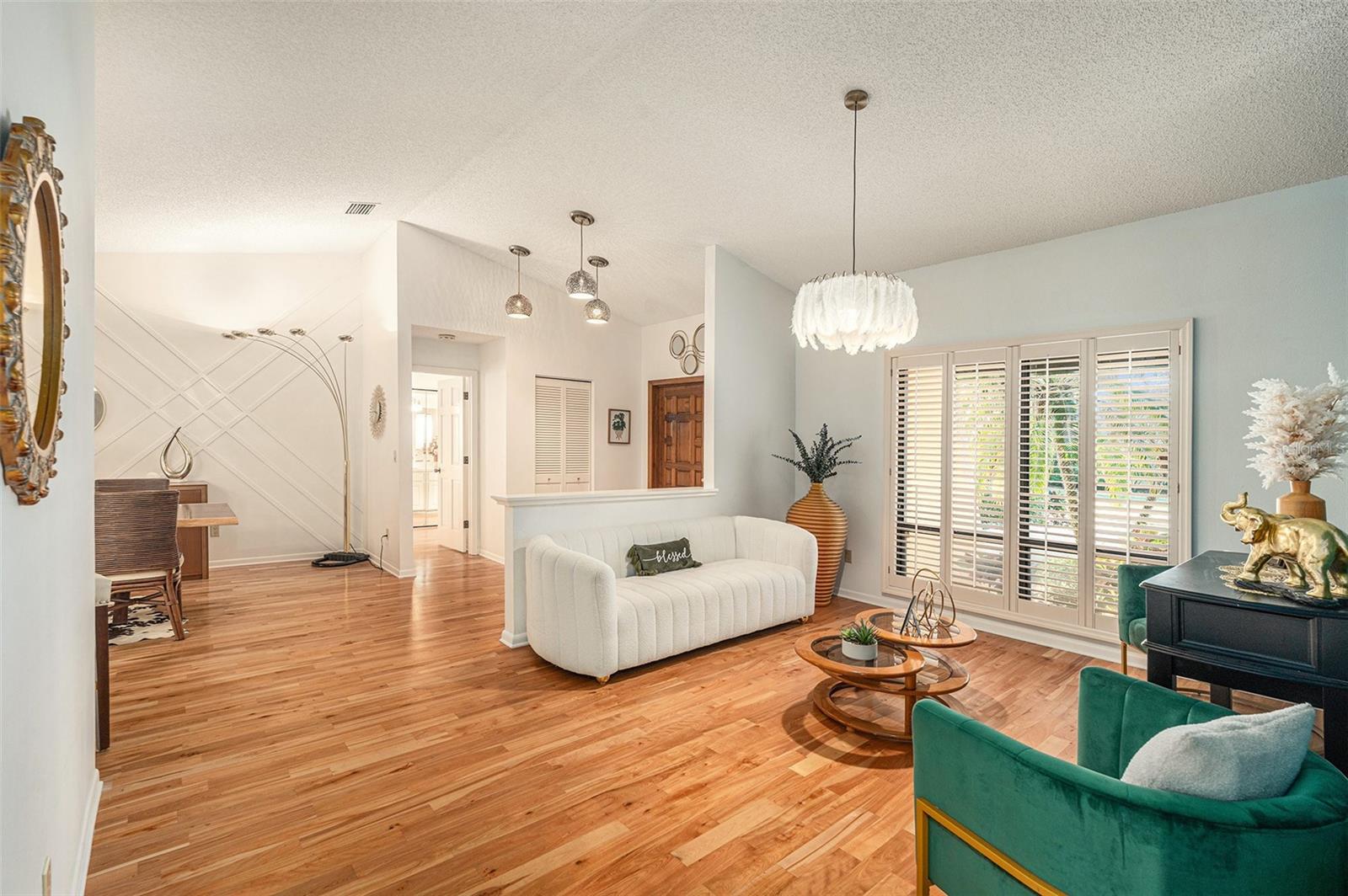 Staged living room open to foyer