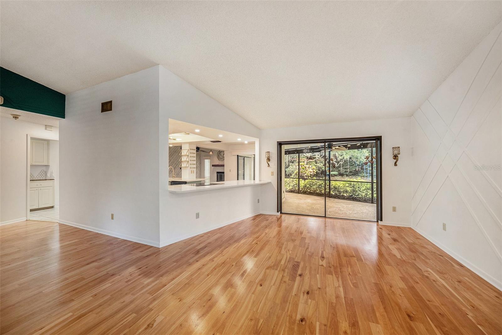 Large dining room open to kitchen with sliders to lanai