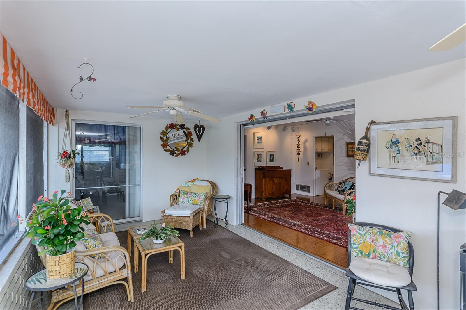 Sunroom with pocket sliders opening up to the family room/kitchen - perfect for entertaining