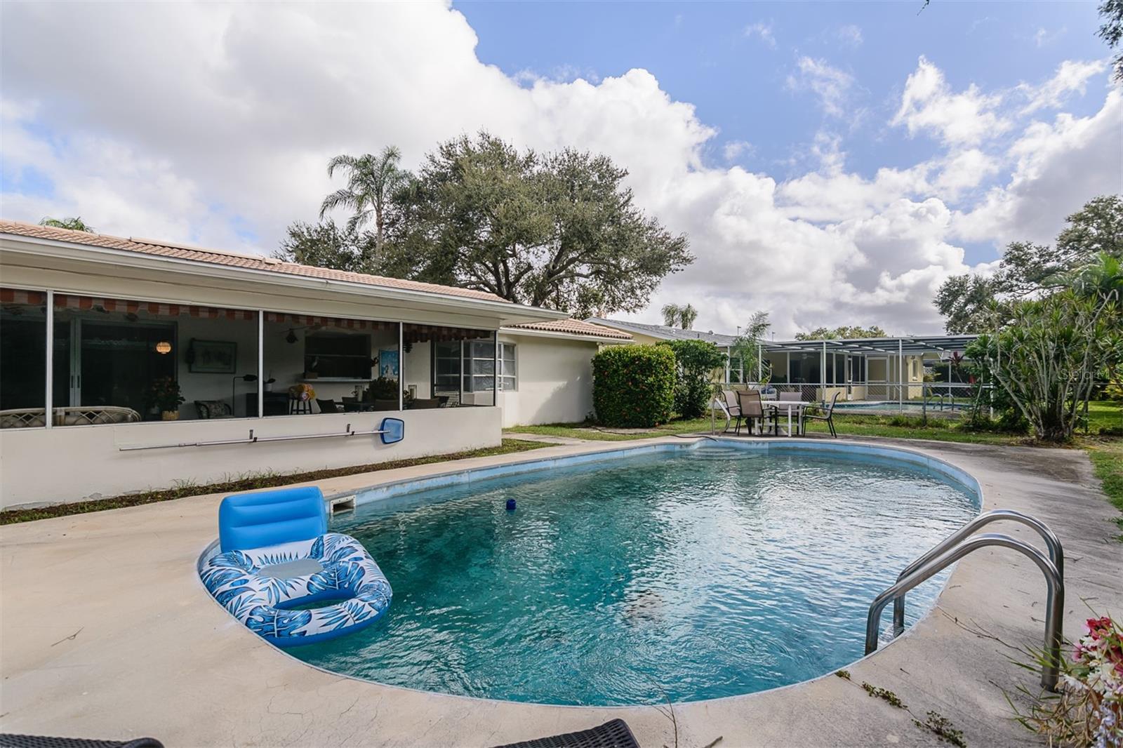 Large open pool deck and fenced yard