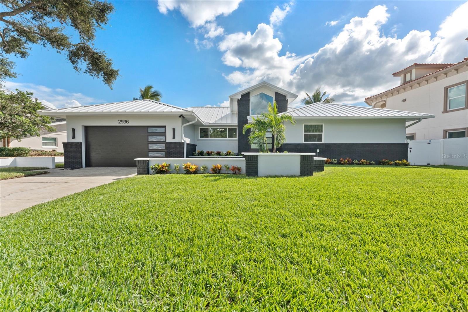 Sleek standing seam metal roof adds modern style and long-lasting durability.