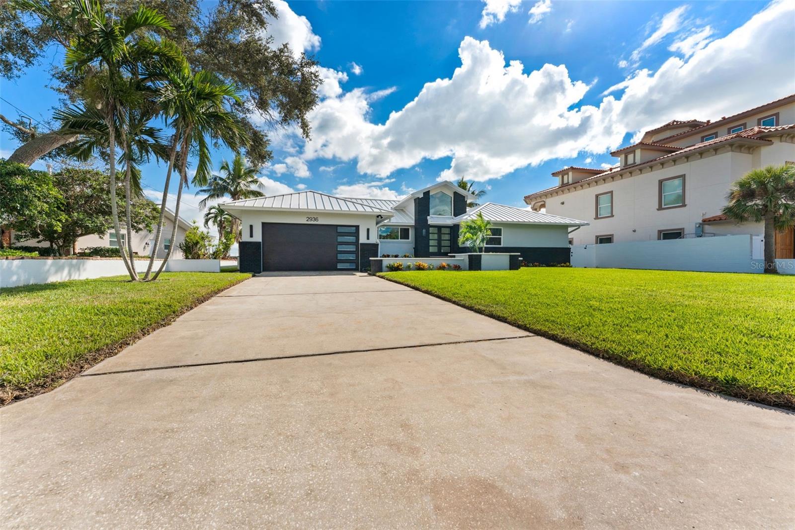 Spacious parking pad with plenty of room for guests, boats, or an RV — perfect for coastal living.