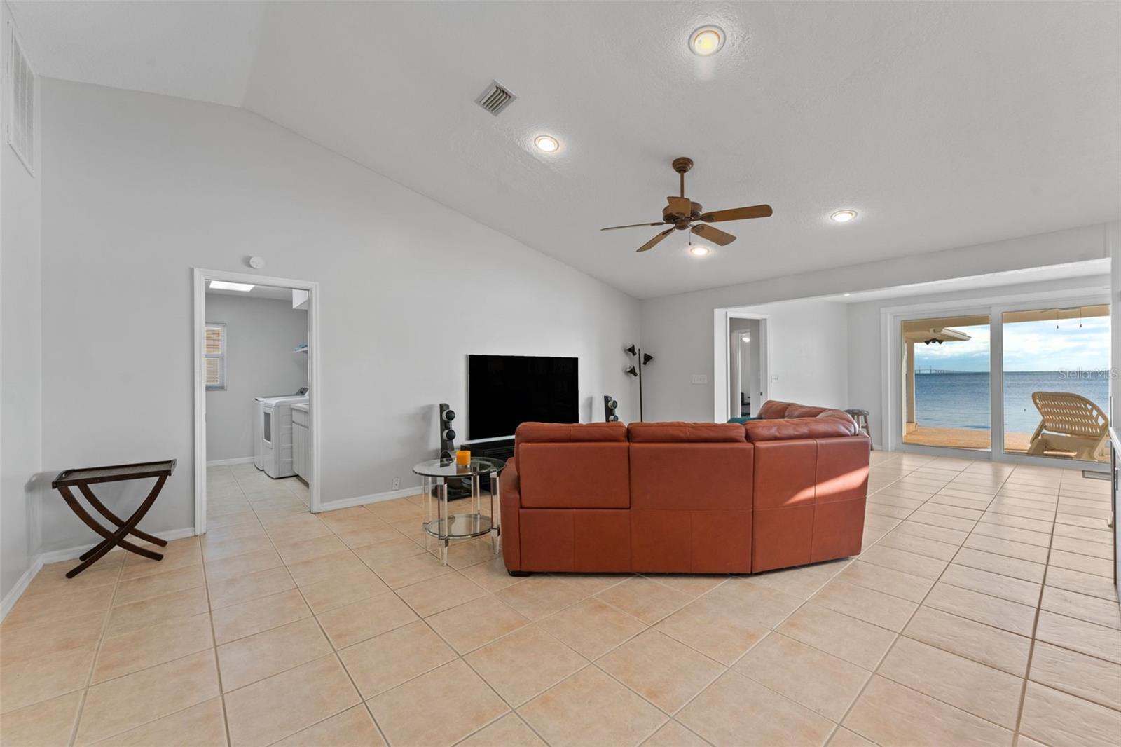 Inviting living room with convenient pocket door access to the laundry room.