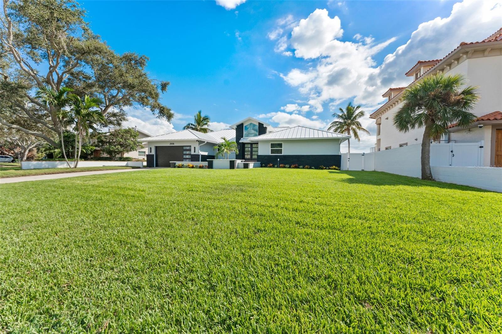 Expansive front yard with fresh landscaping and modern curb appeal.