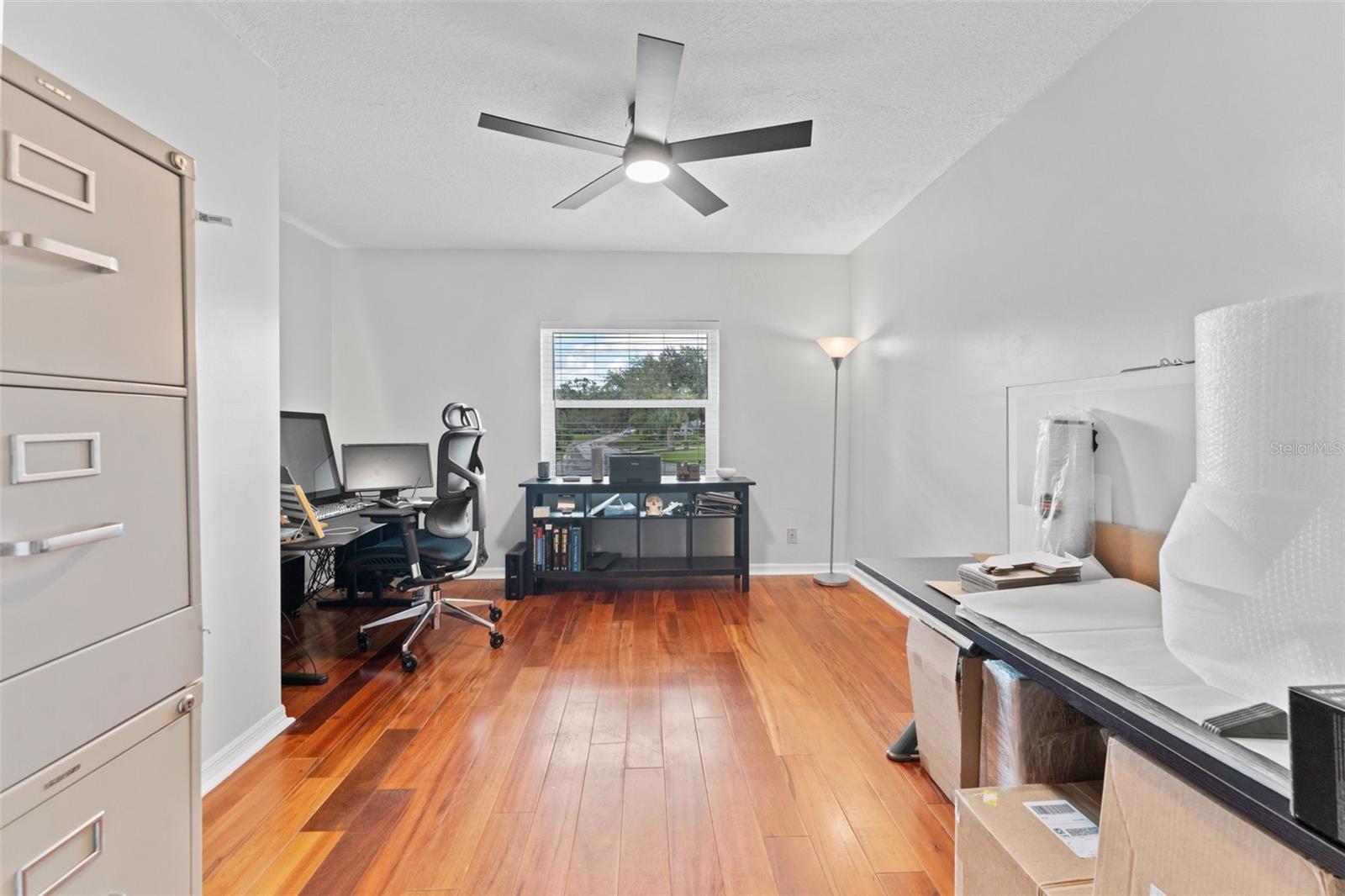 Bedroom 2 featuring hardwood floors, offering a bright and inviting space for family, guests, or as an office.