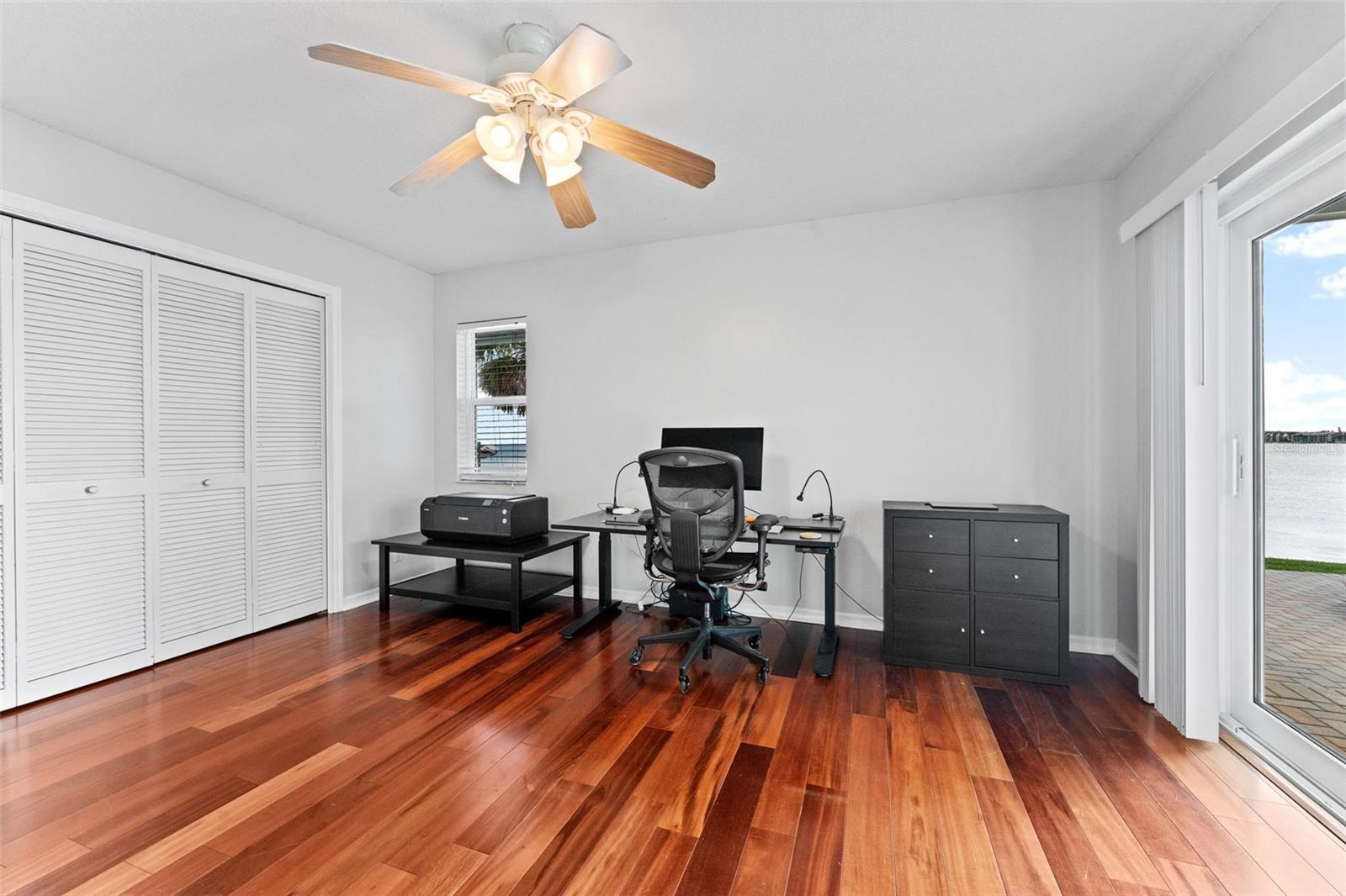 Spacious Bedroom 4 with hardwood flooring and generous closet space, perfect for comfort and functionality.