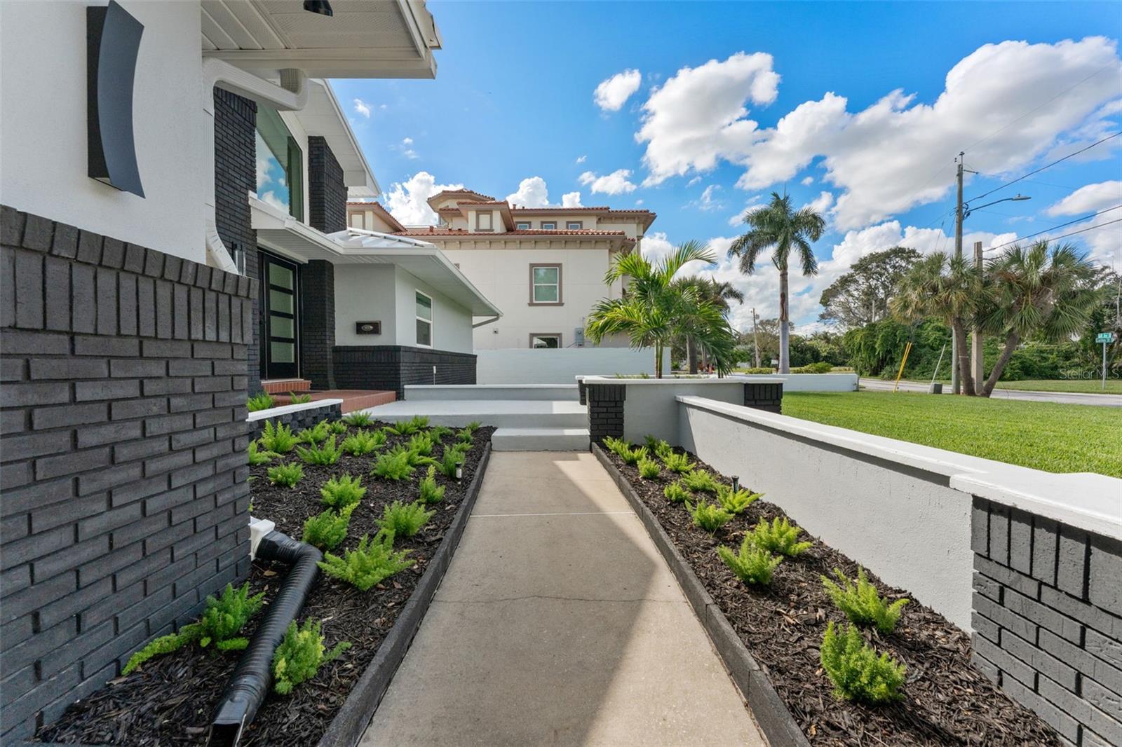 Beautifully landscaped walkway creates a warm and inviting entrance to the home.