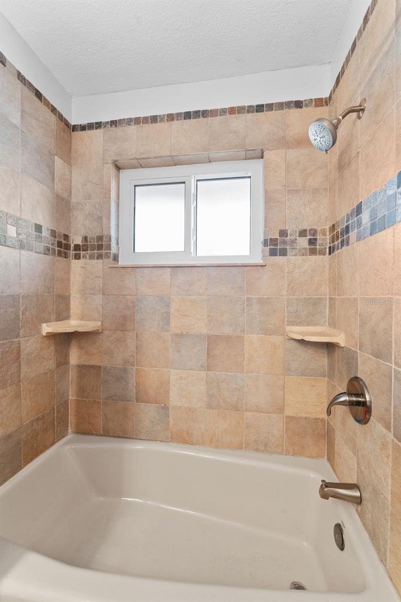 Hall bathroom with a convenient tub/shower combo, combining functionality and style.
