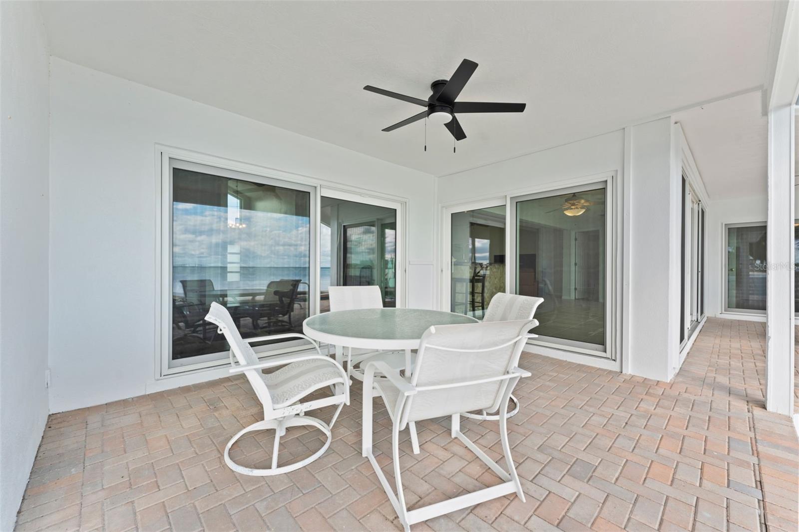 Covered back patio, ideal for relaxing or entertaining with your favorite outdoor furniture.