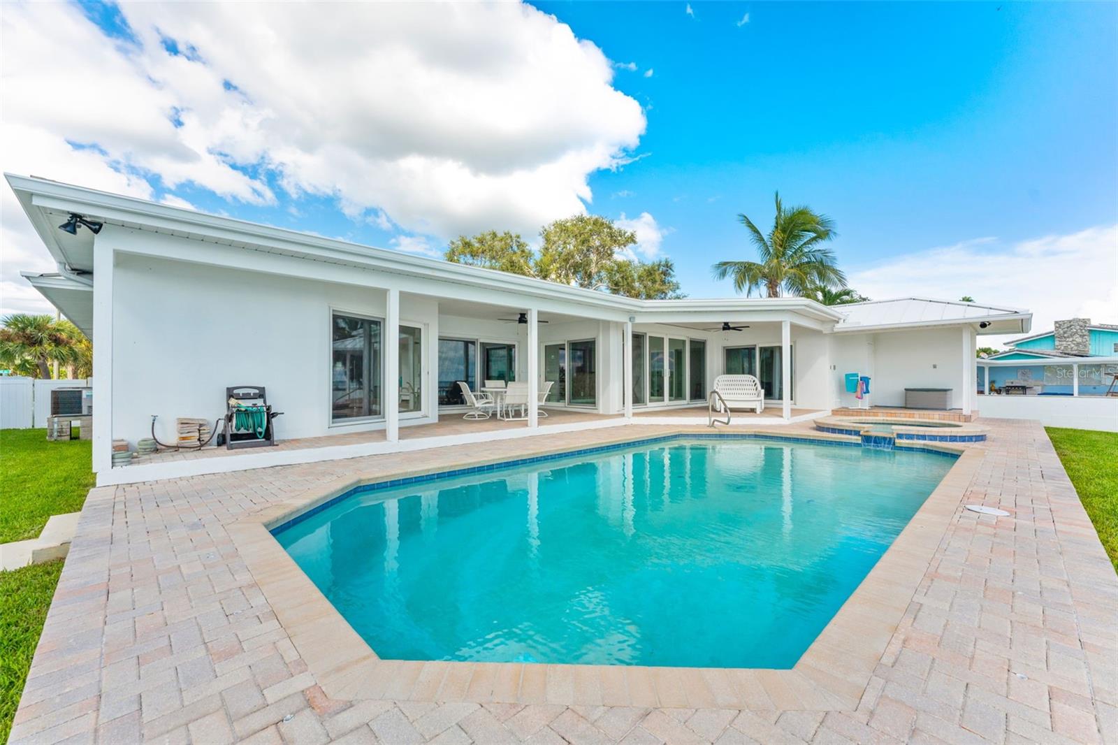 Beautiful brick paver pool deck, providing a stylish and durable space for outdoor living and entertaining.