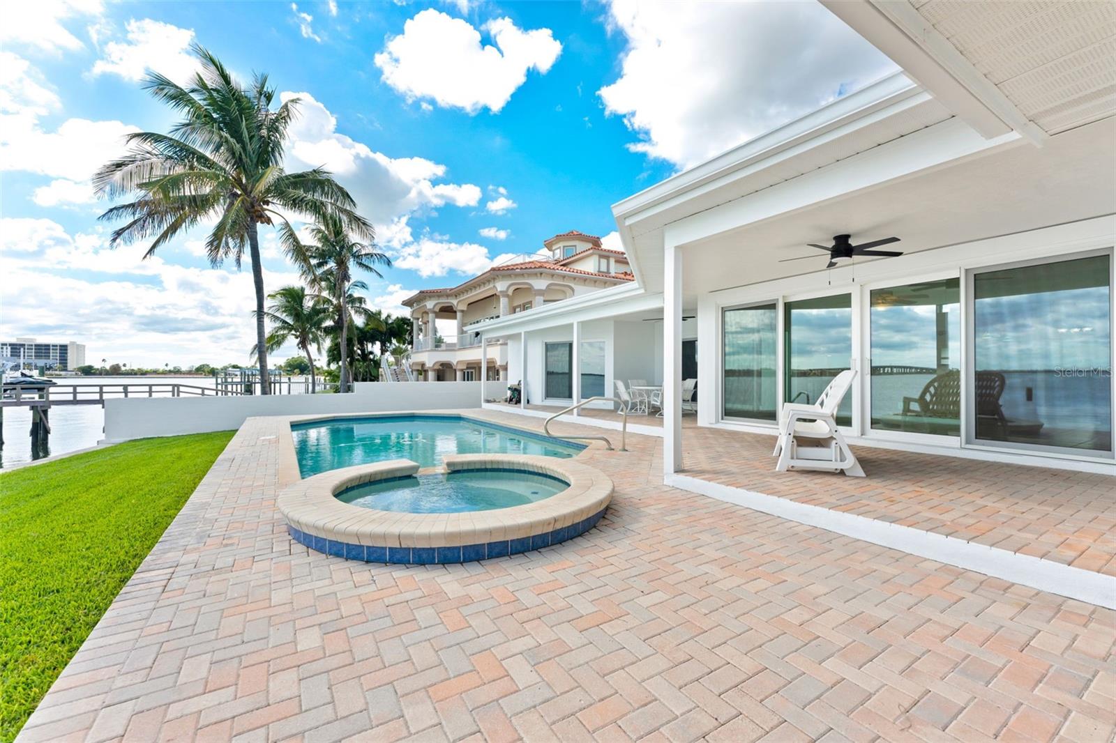 Stunning outdoor oasis featuring covered patios, a sparkling pool, and a relaxing spa—perfect for entertaining or unwinding.