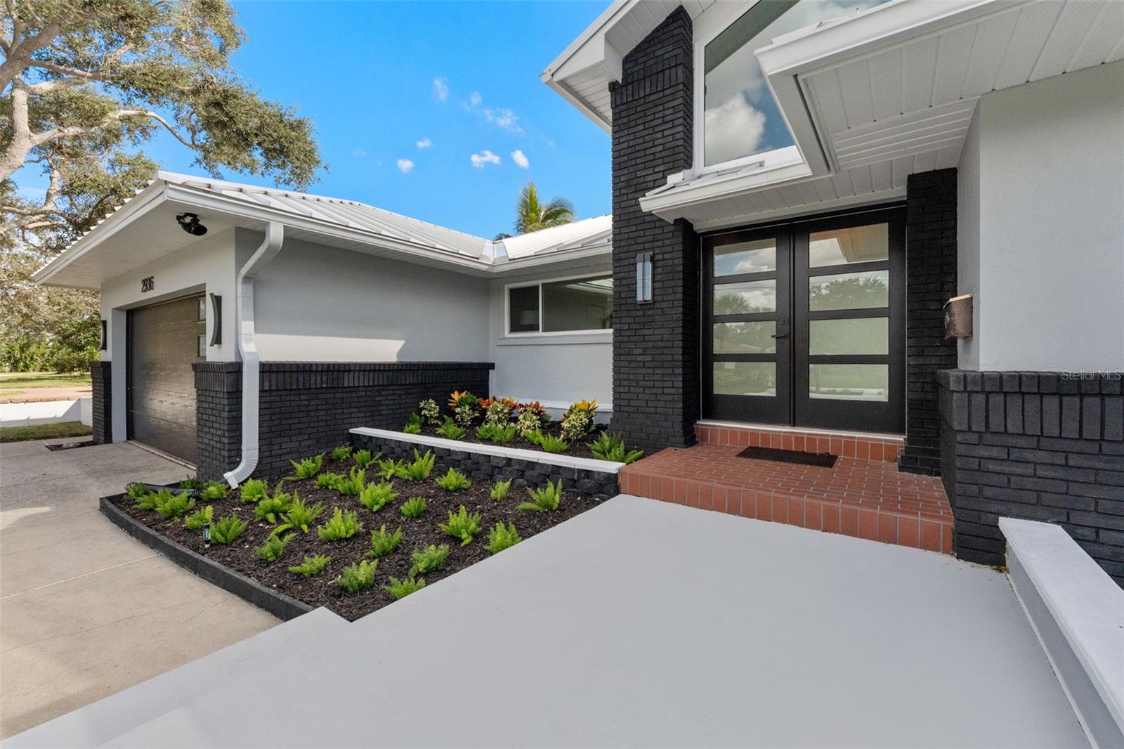 Freshly painted exterior with new gutters enhances the home’s modern curb appeal and clean design.