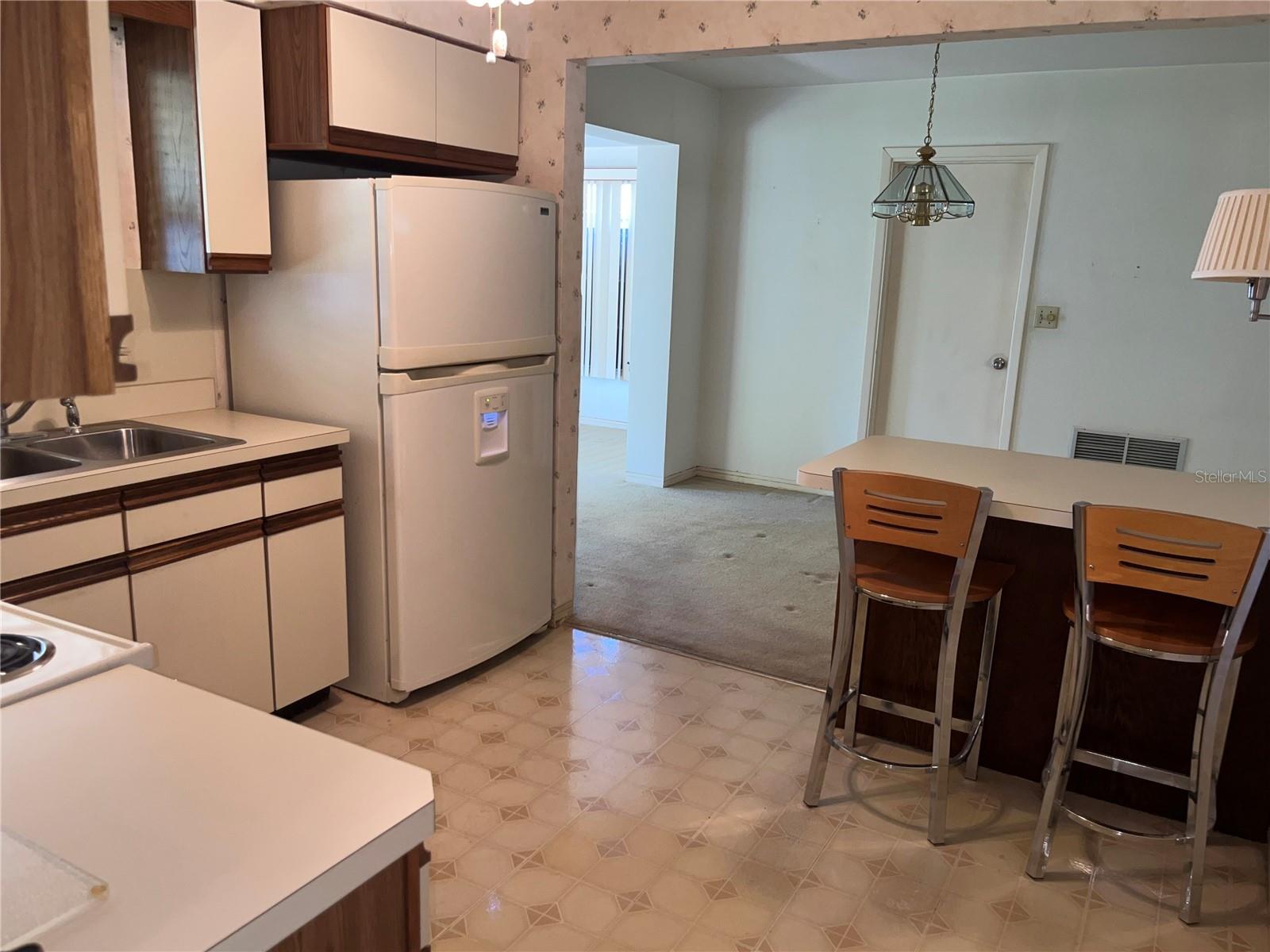 Kitchen Breakfast Bar to Dining Area and Bonus Room