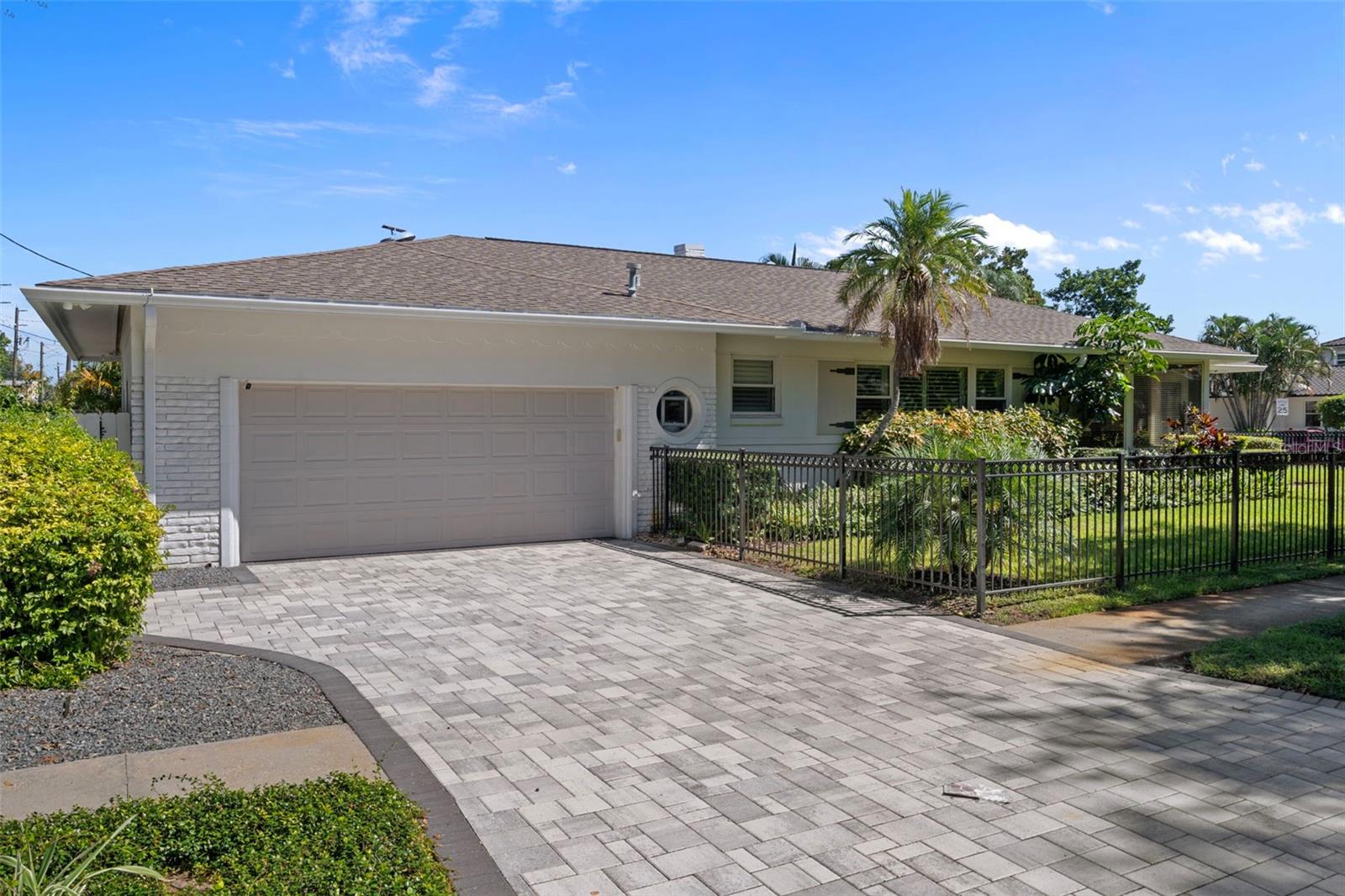 Spacious 2-car garage with newer pavers installed in the driveway parking pad.