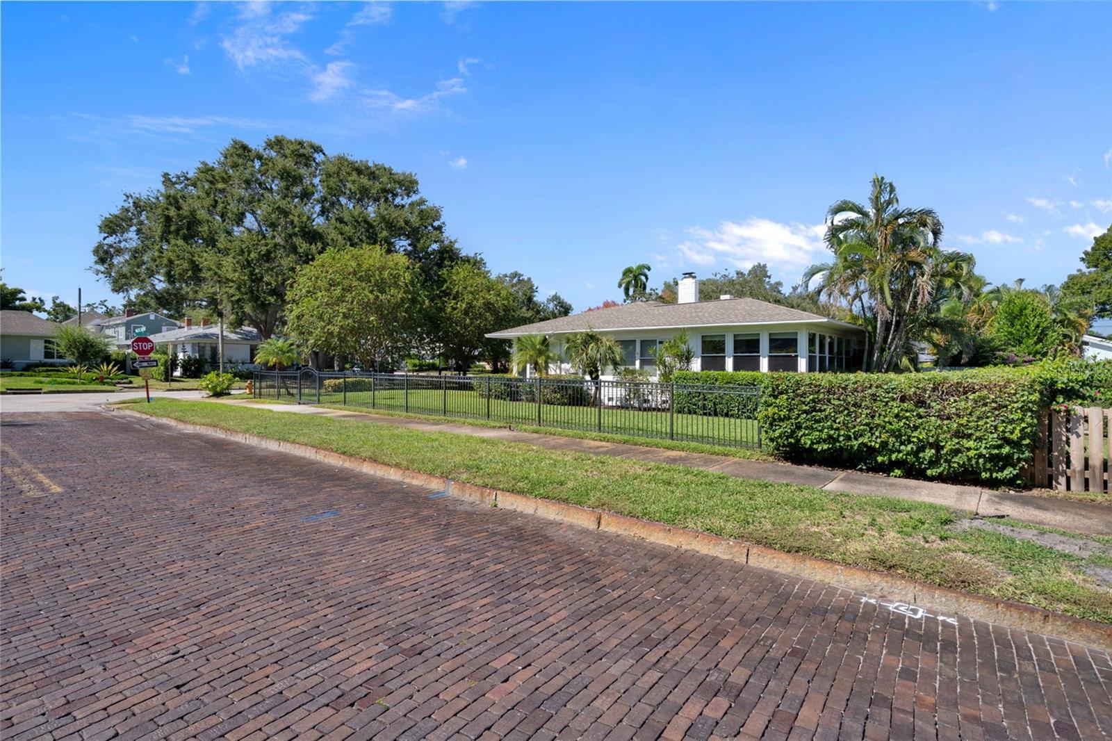 This is the side yard. The home is situated on a wide brick street.