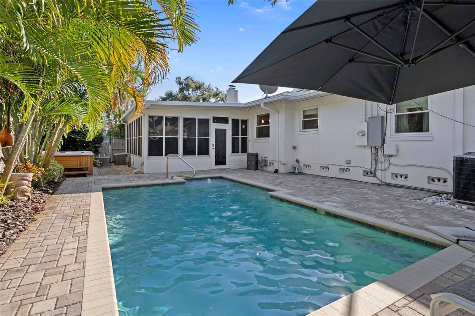 Sparkling saltwater pool with paver patio.