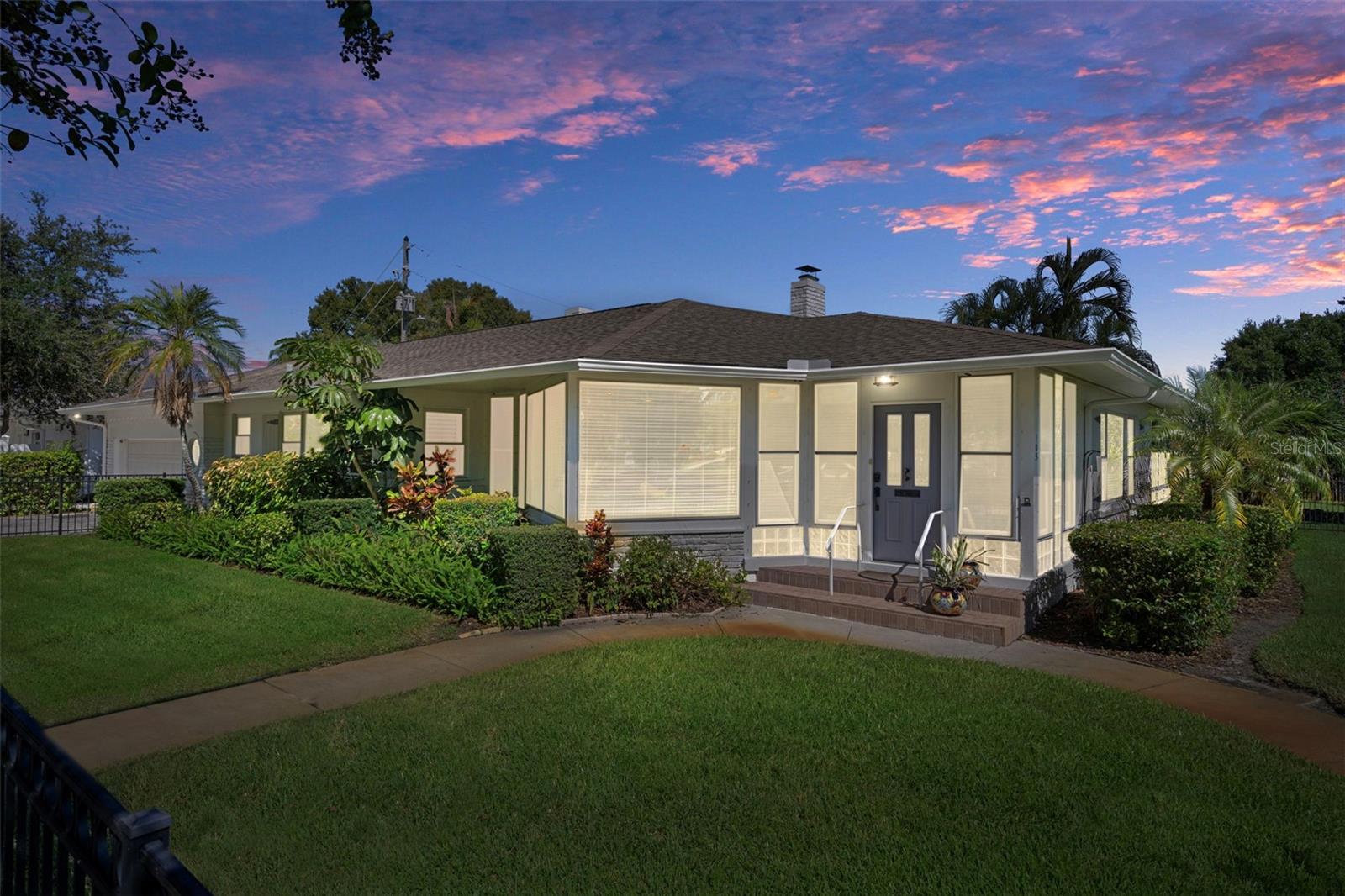 The home illuminated beautifully at twilight.