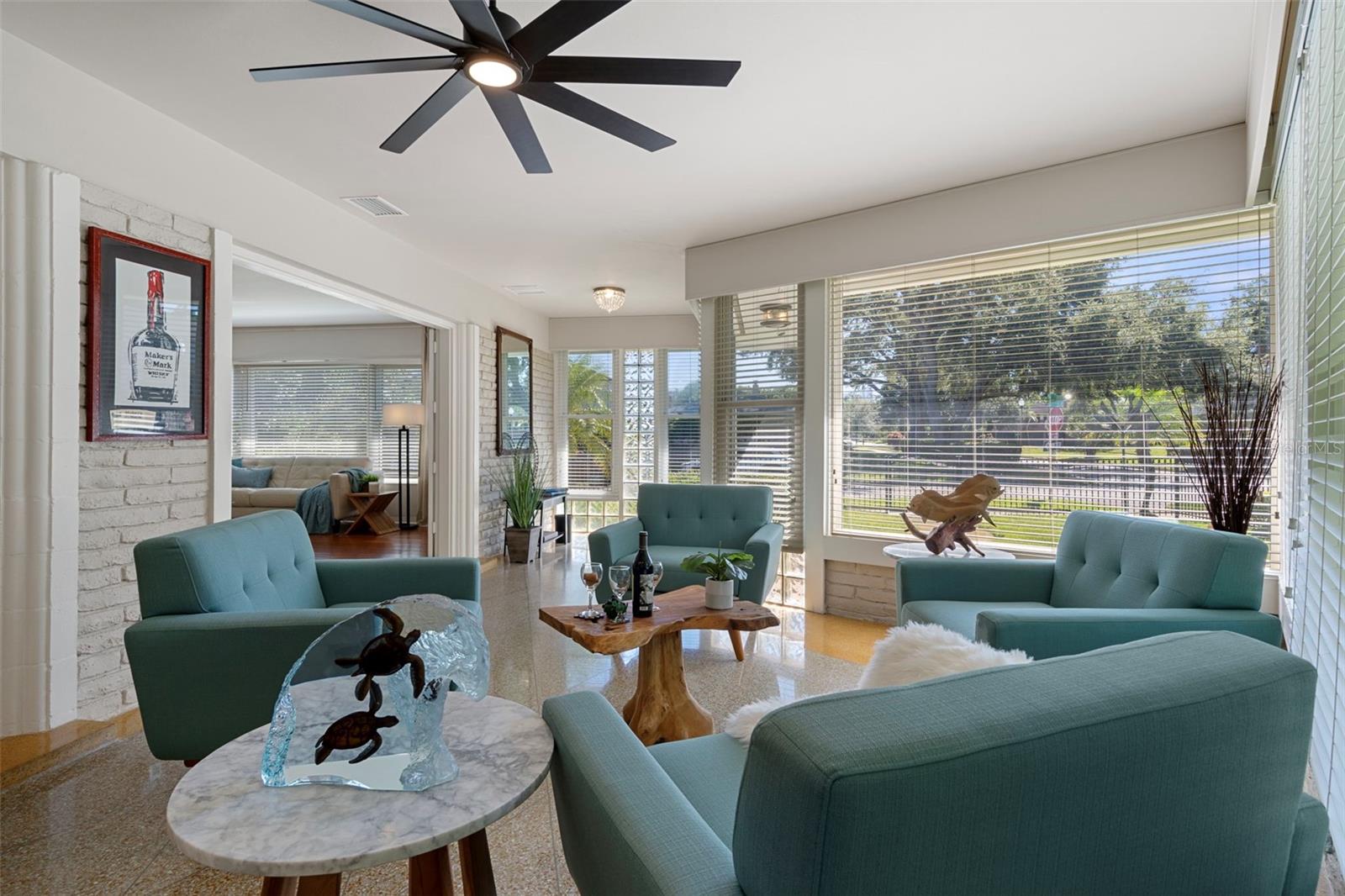 The sitting area opens through French doors to the living room.