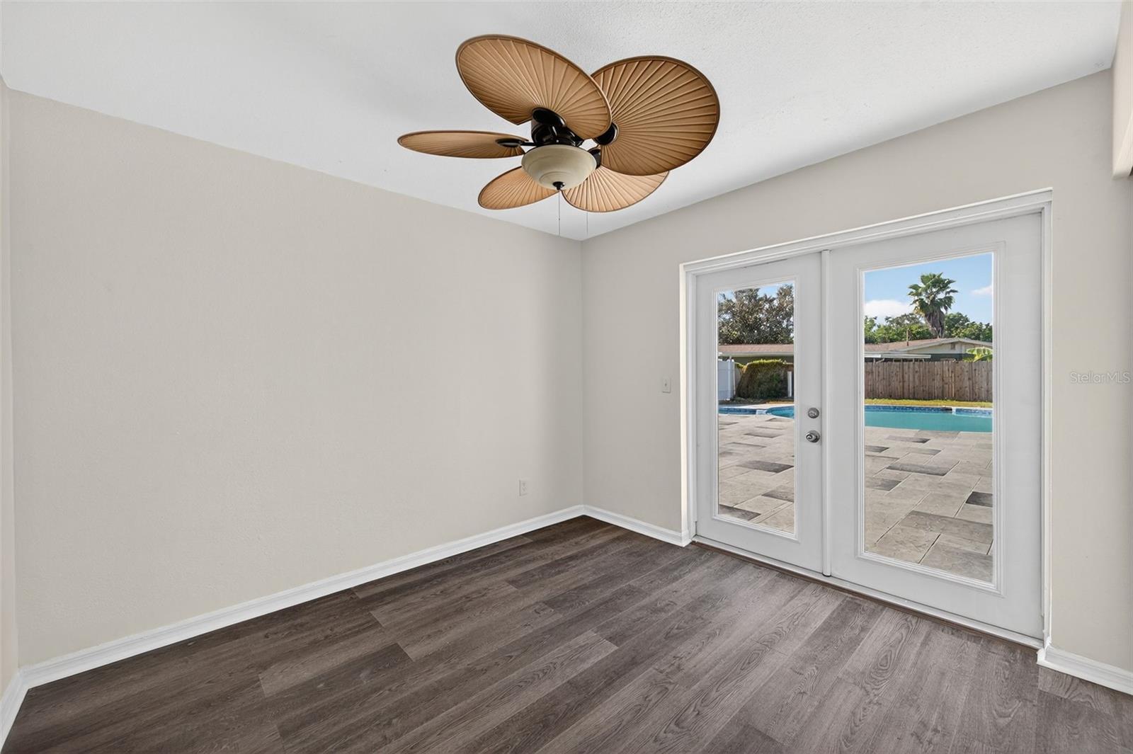 Bedroom 3 with access to the backyard and swimming pool