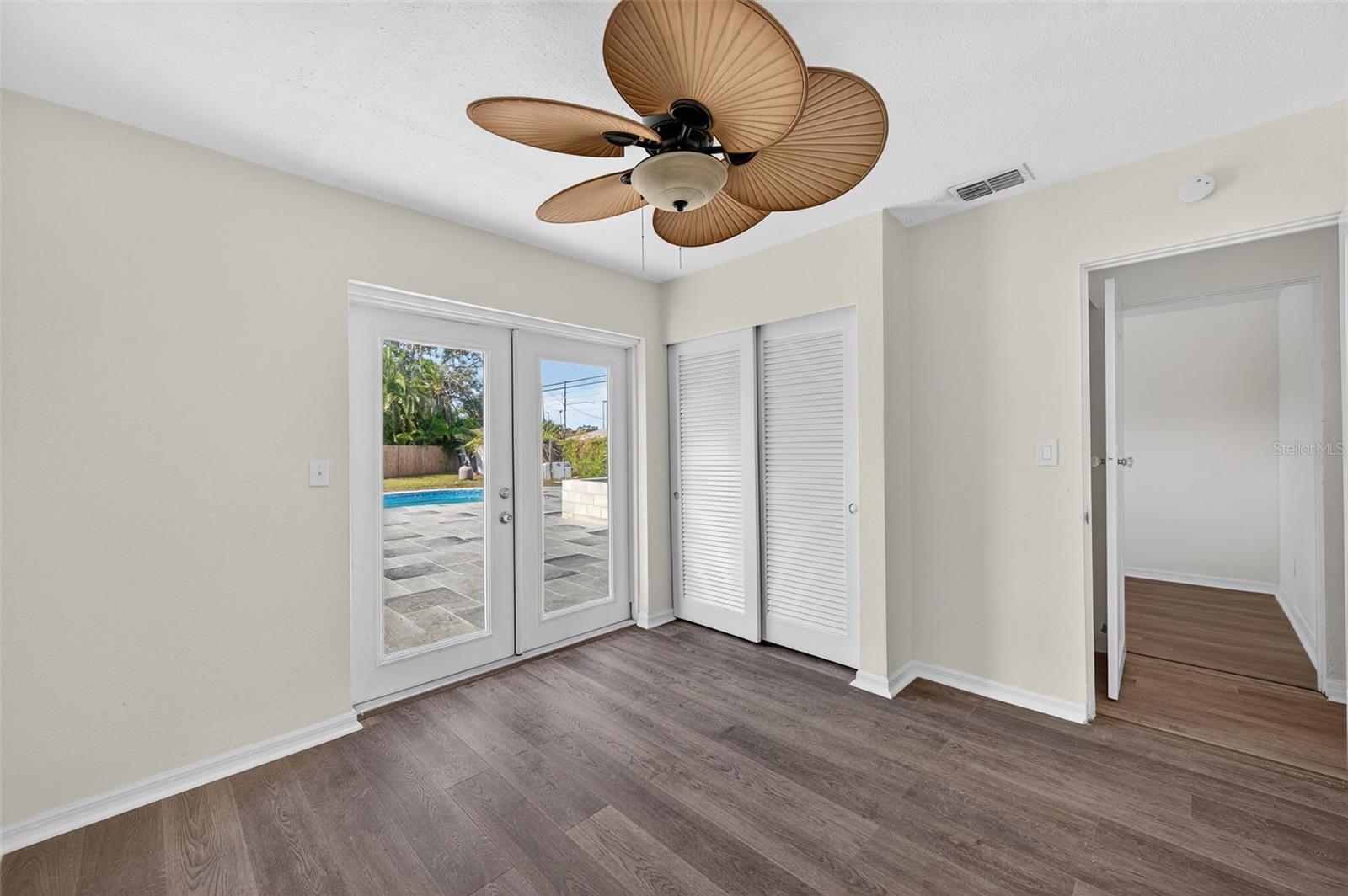 Bedroom 3 with access to the backyard and swimming pool