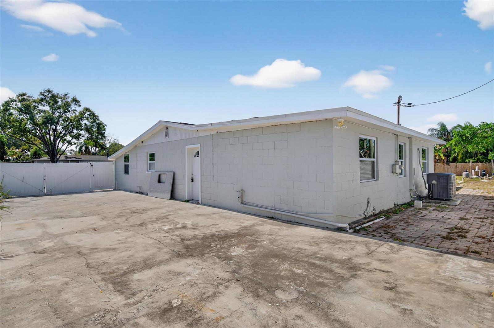 Fenced in parking area on side of the house