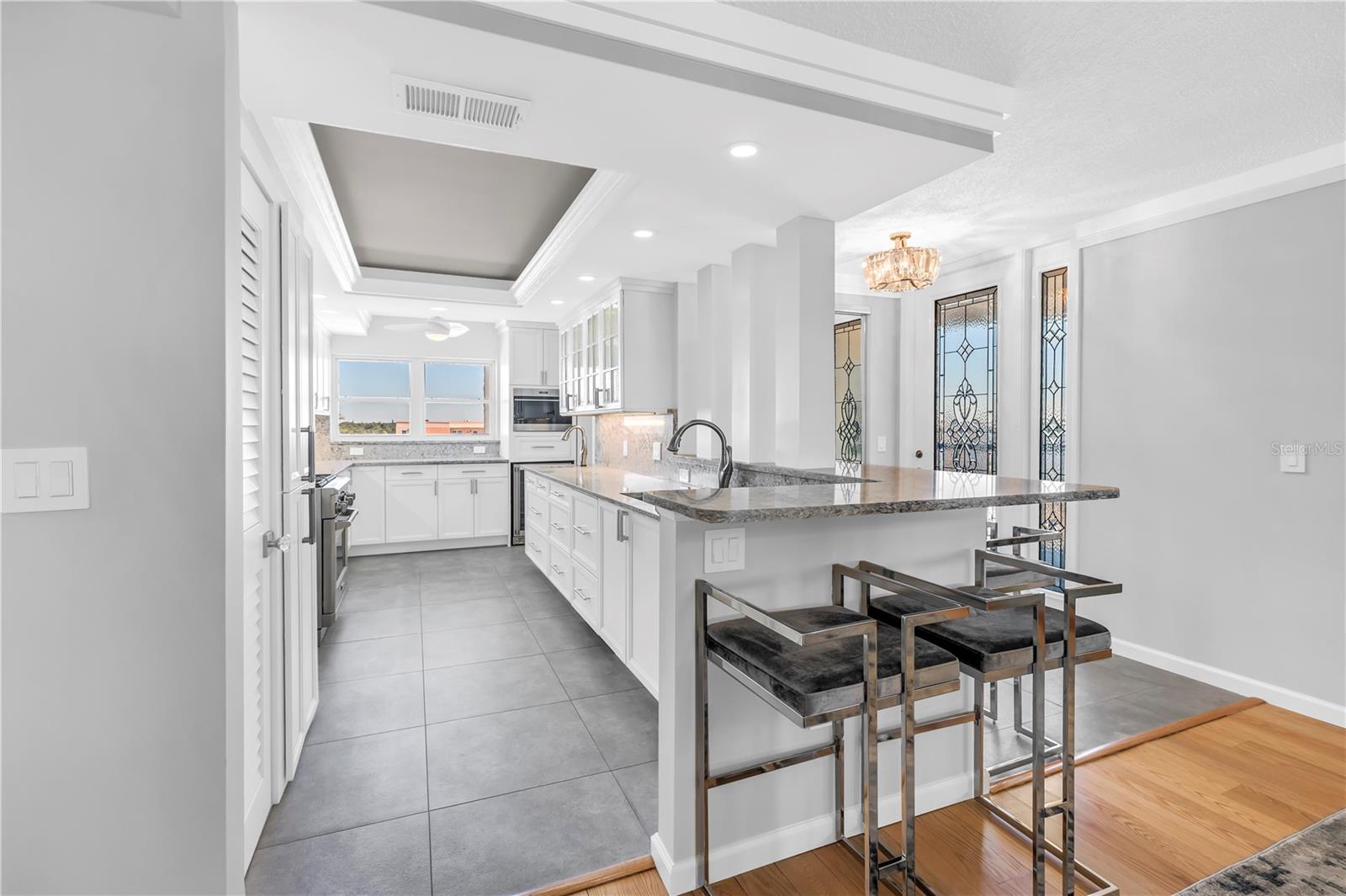 Kitchen with tray ceiling. Plenty of natural light by day and ample lighting for evening