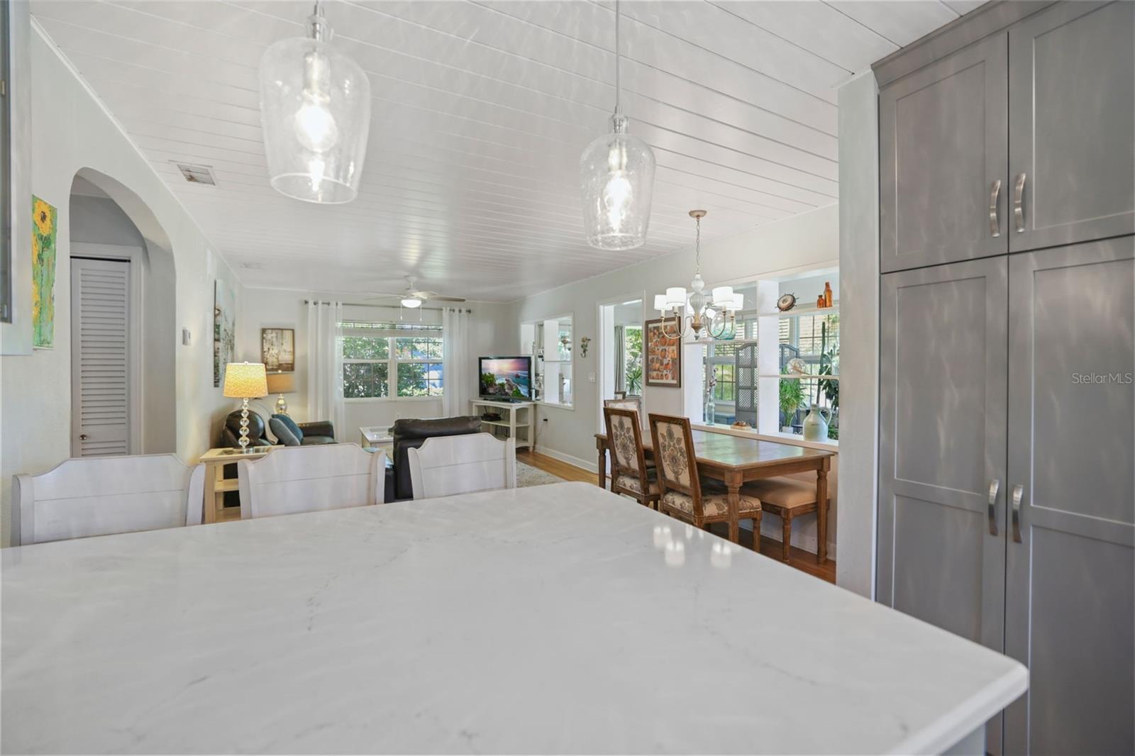 Large whit quartz kitchen island - pull up a chair