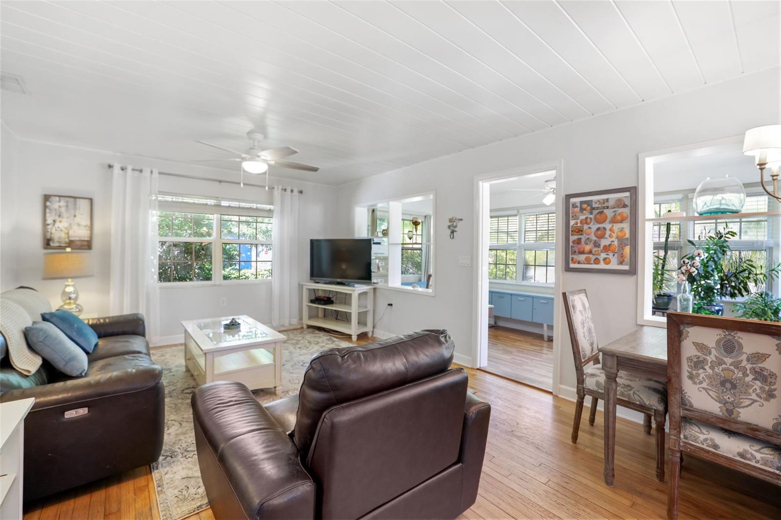 Living Room includes original hardwood floors and beadboard ceiling opens to the kitchen and entryway. If you like light and bright you won't be disappointed.