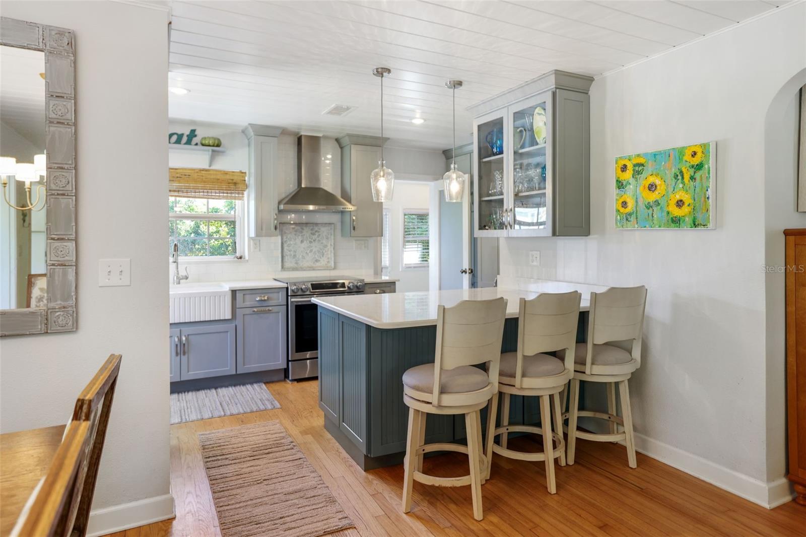 Lage quartz island with custom coordinating cabinetry