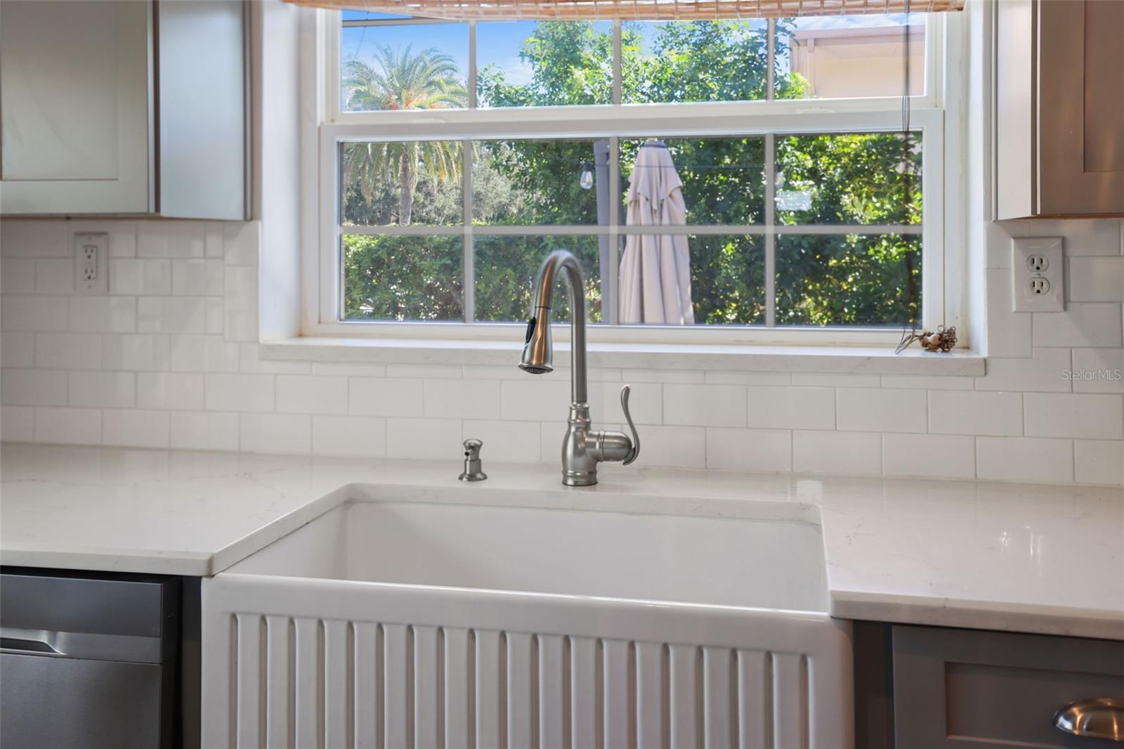 Farmhouse sink, White Quarta Counters and White subway tile backsplash
