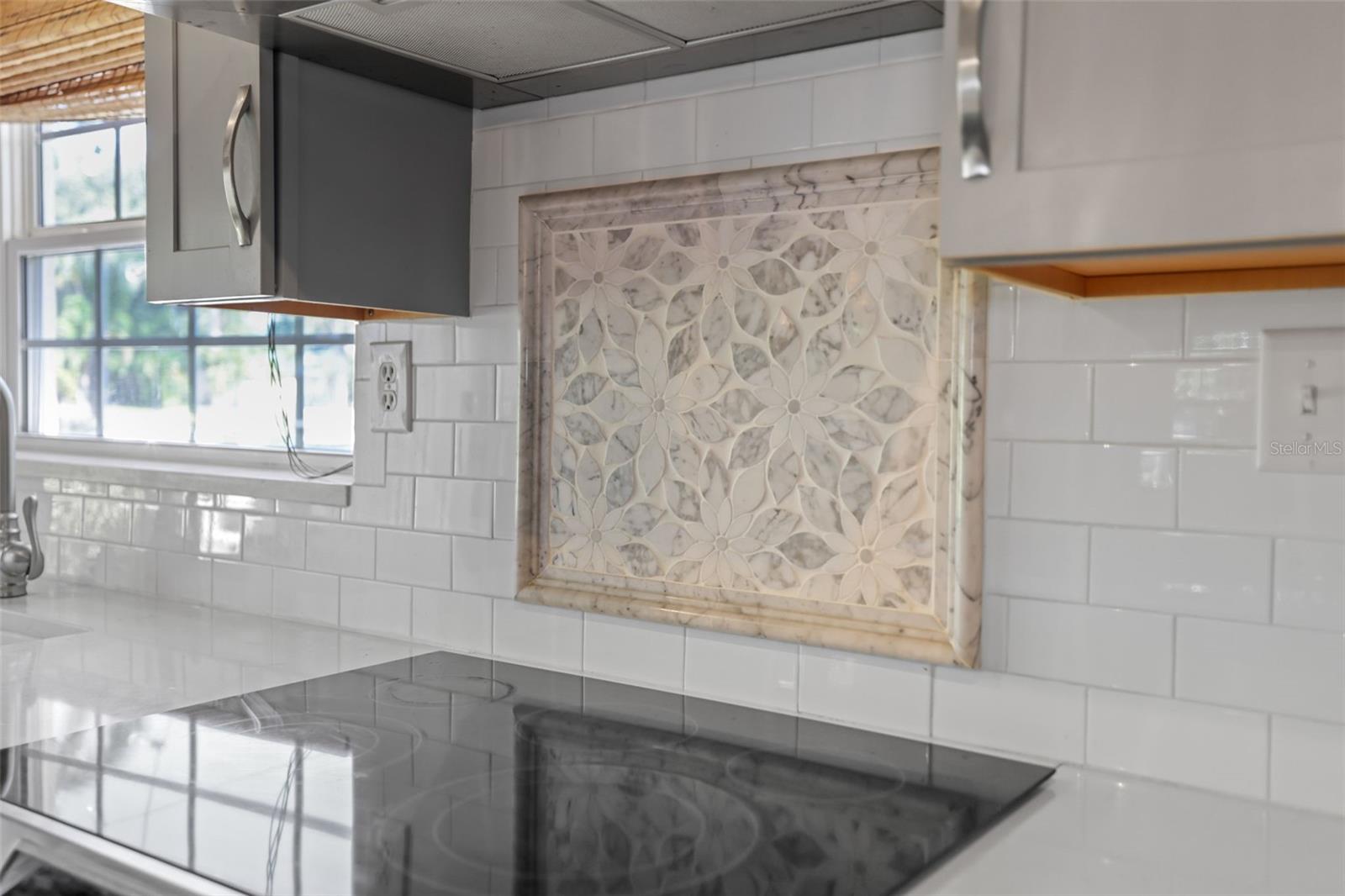 Pretty tile Mosaic under Range hood