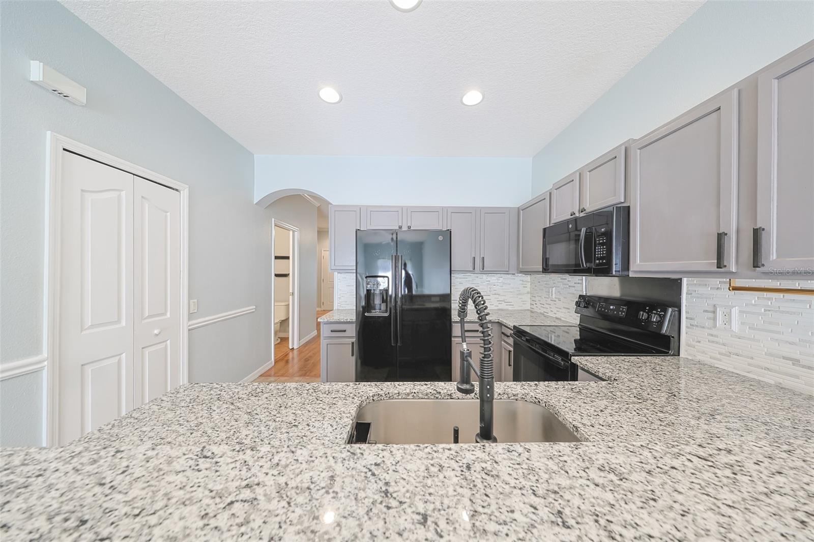 Backsplash, upgraded black faucet, walk-in pantry and more!