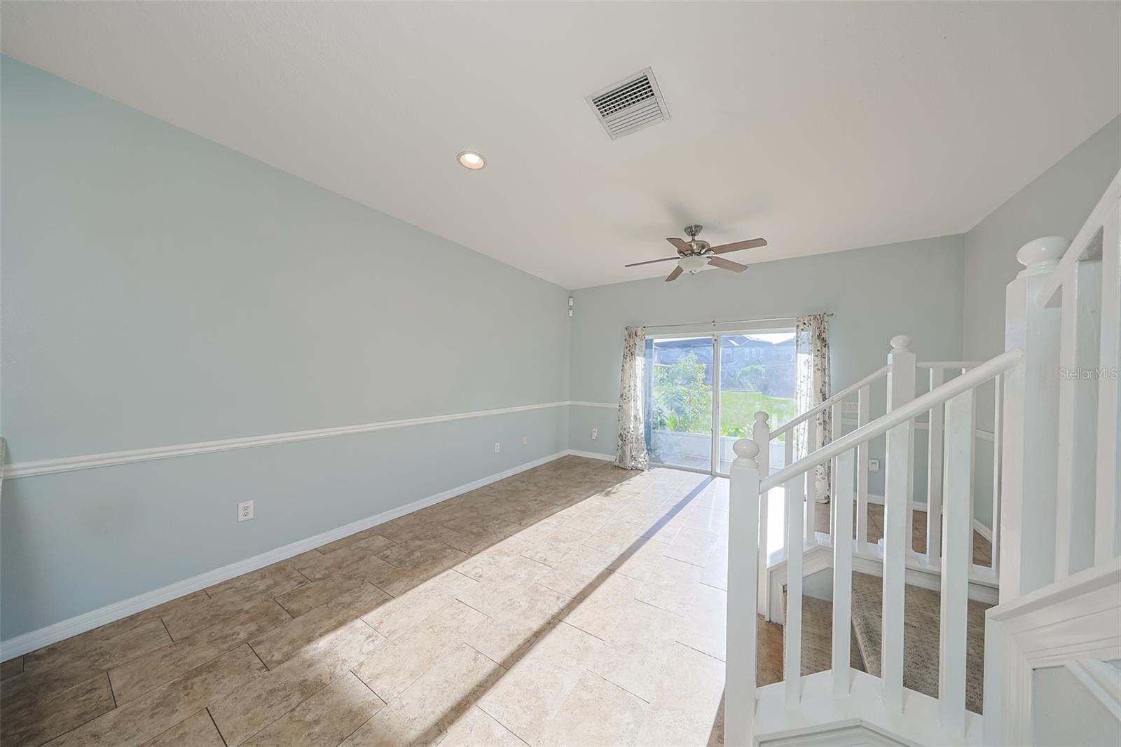 Kitchen opens to this family room with attractive chair rail