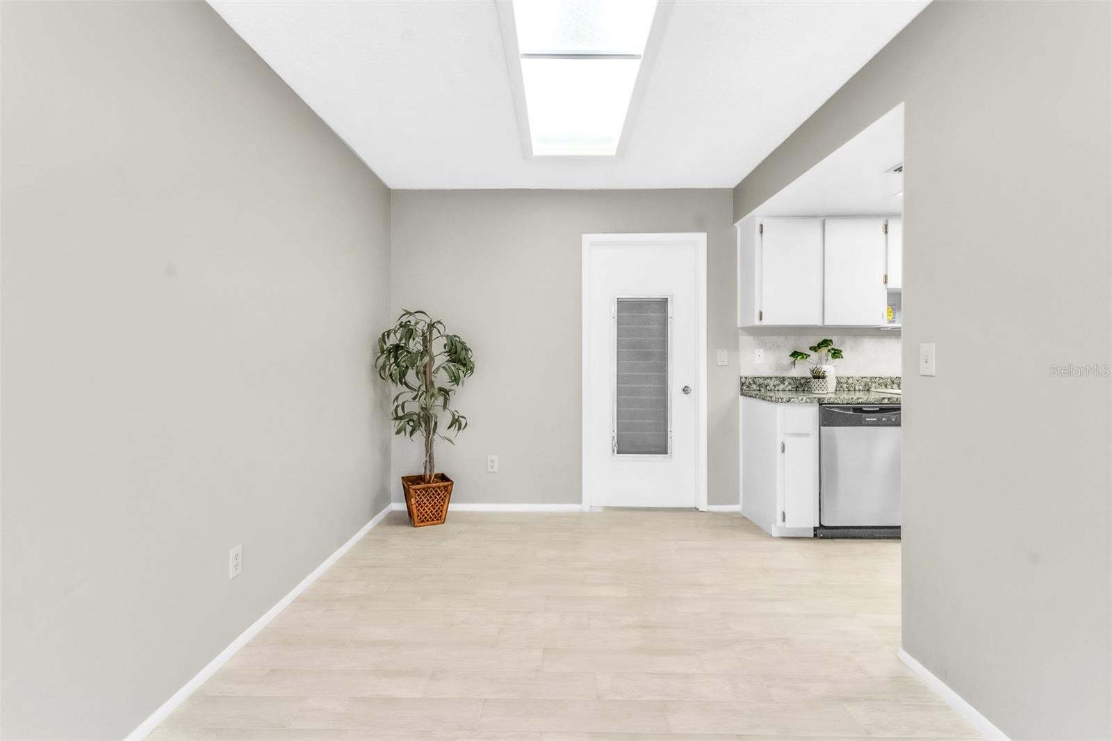 Dining Room- Freshly painted, new tile flooring throughout and skylight
