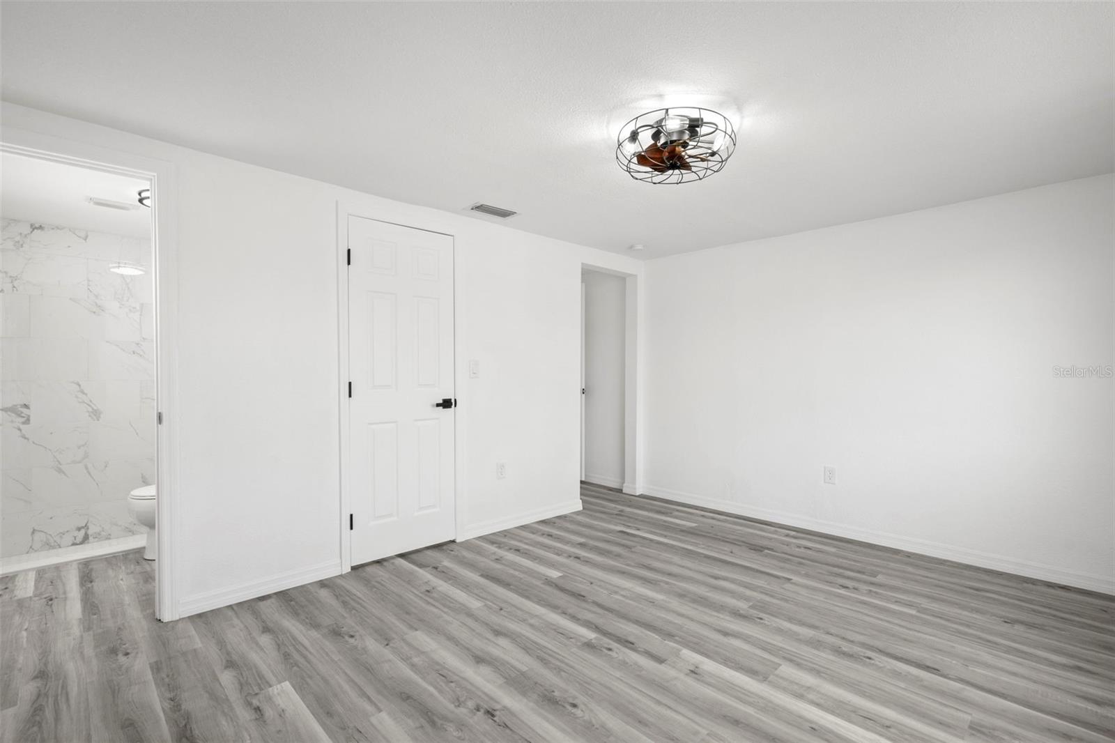 Primary bedroom with bathroom suite