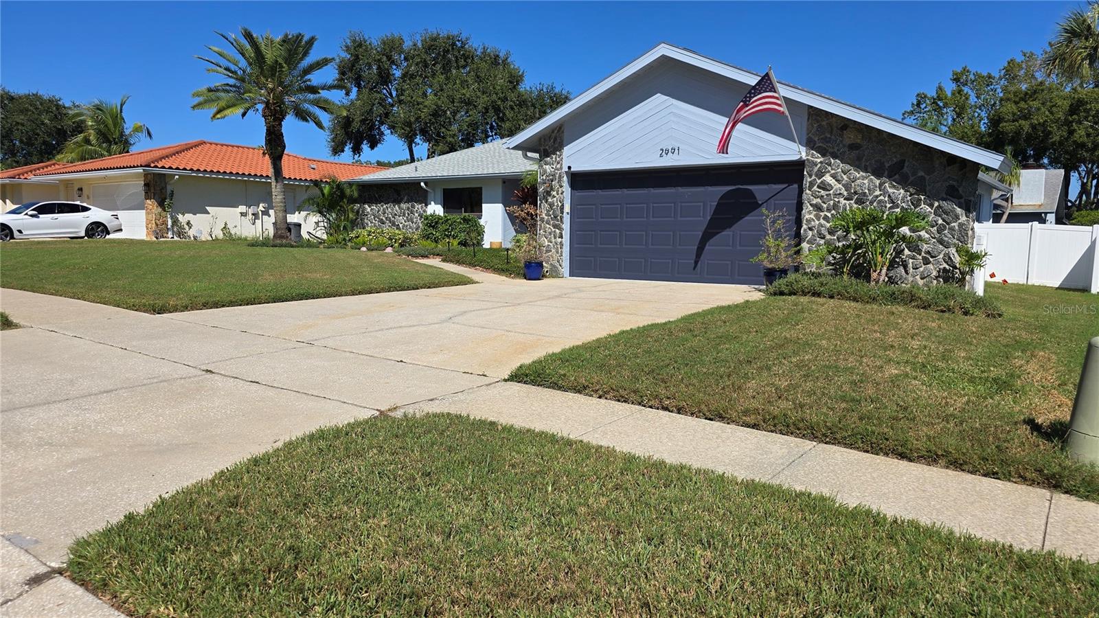 Front side view with large driveway for off street parking.