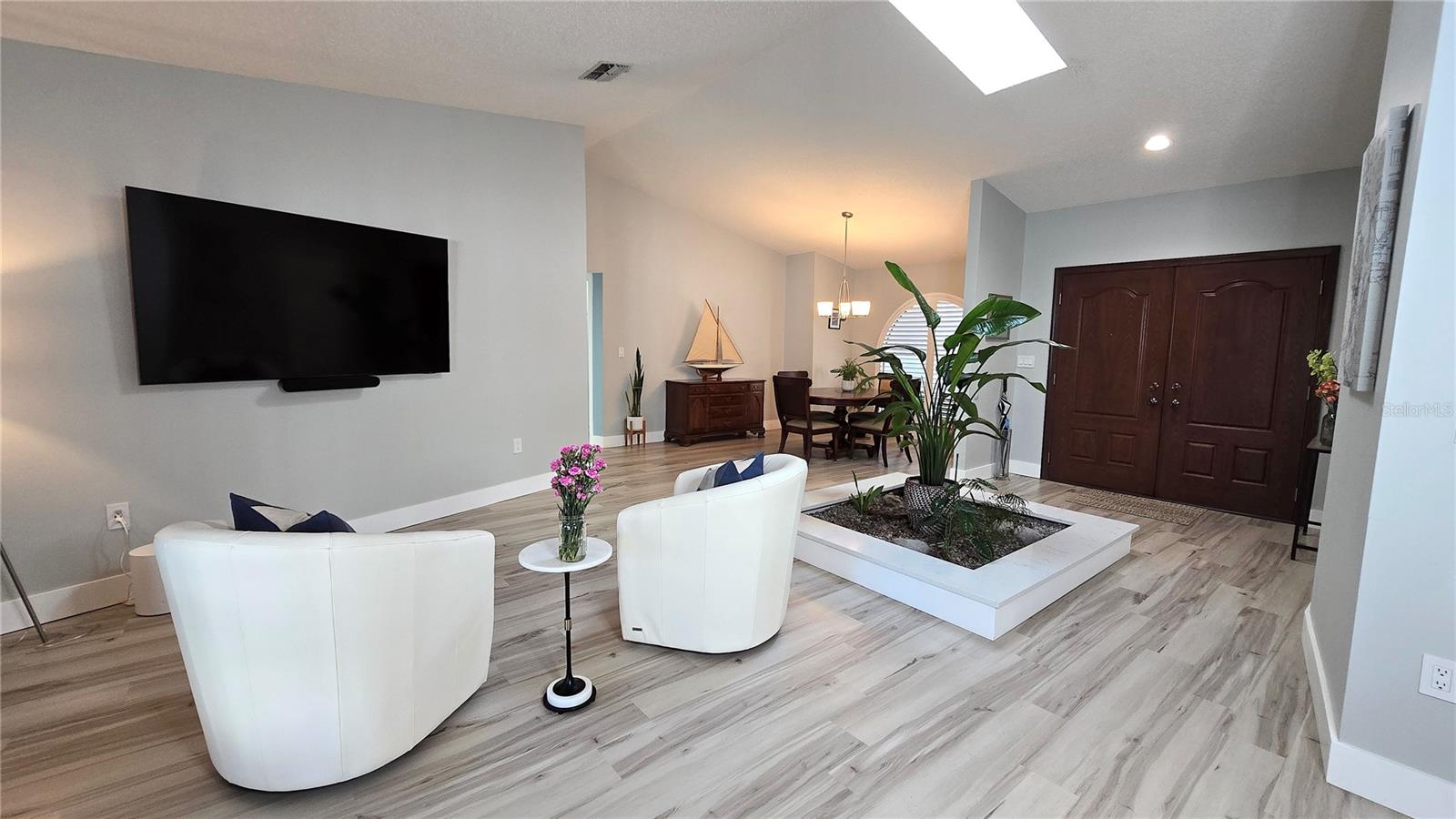 Living Room and entry with skylight with lots of natural lighting.